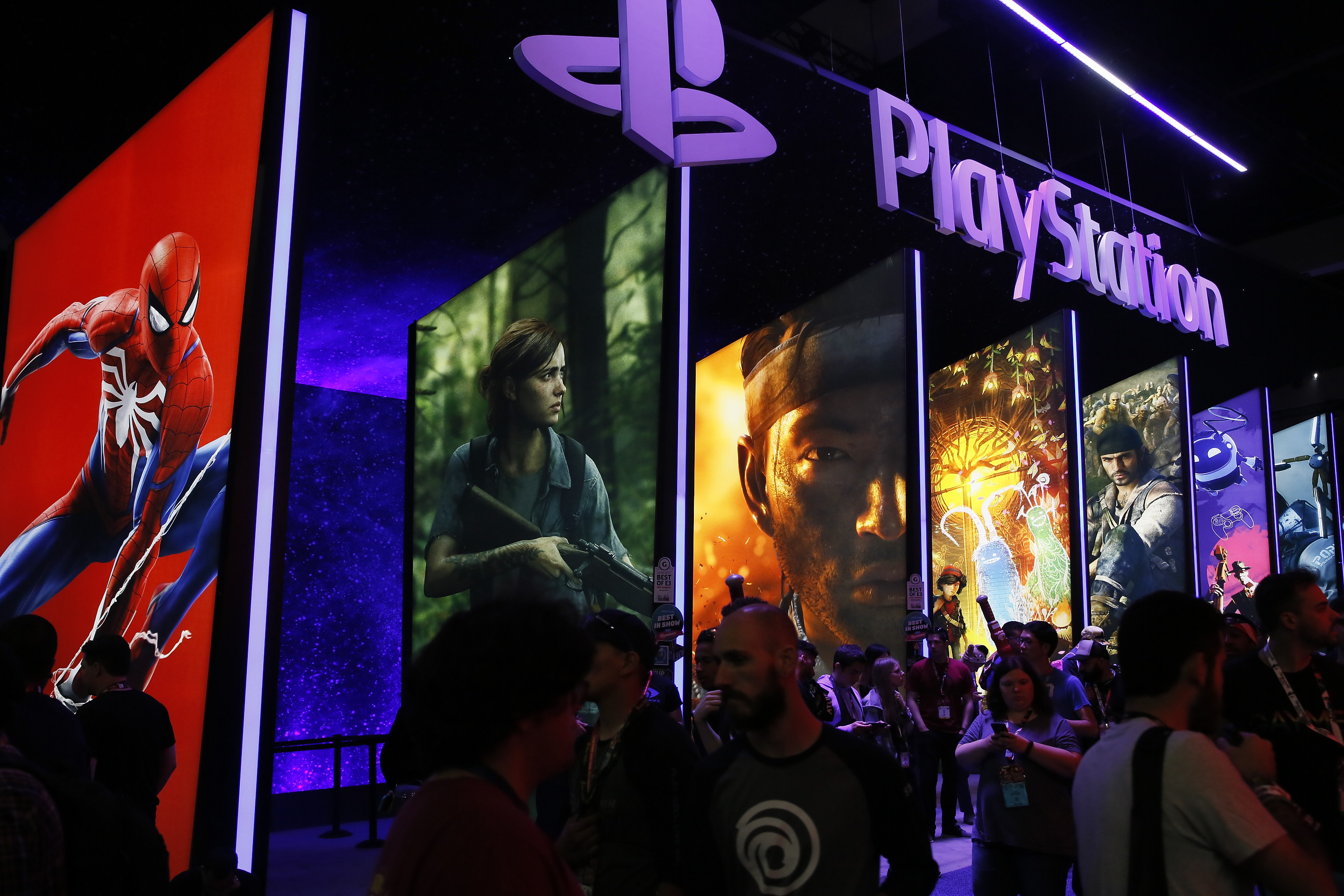 FILE - In this June 14, 2018, file people stand online next to the PlayStation booth at the 24th Electronic Entertainment Expo E3 at the Los Angeles Convention Center. (AP Photo/Damian Dovarganes, File)