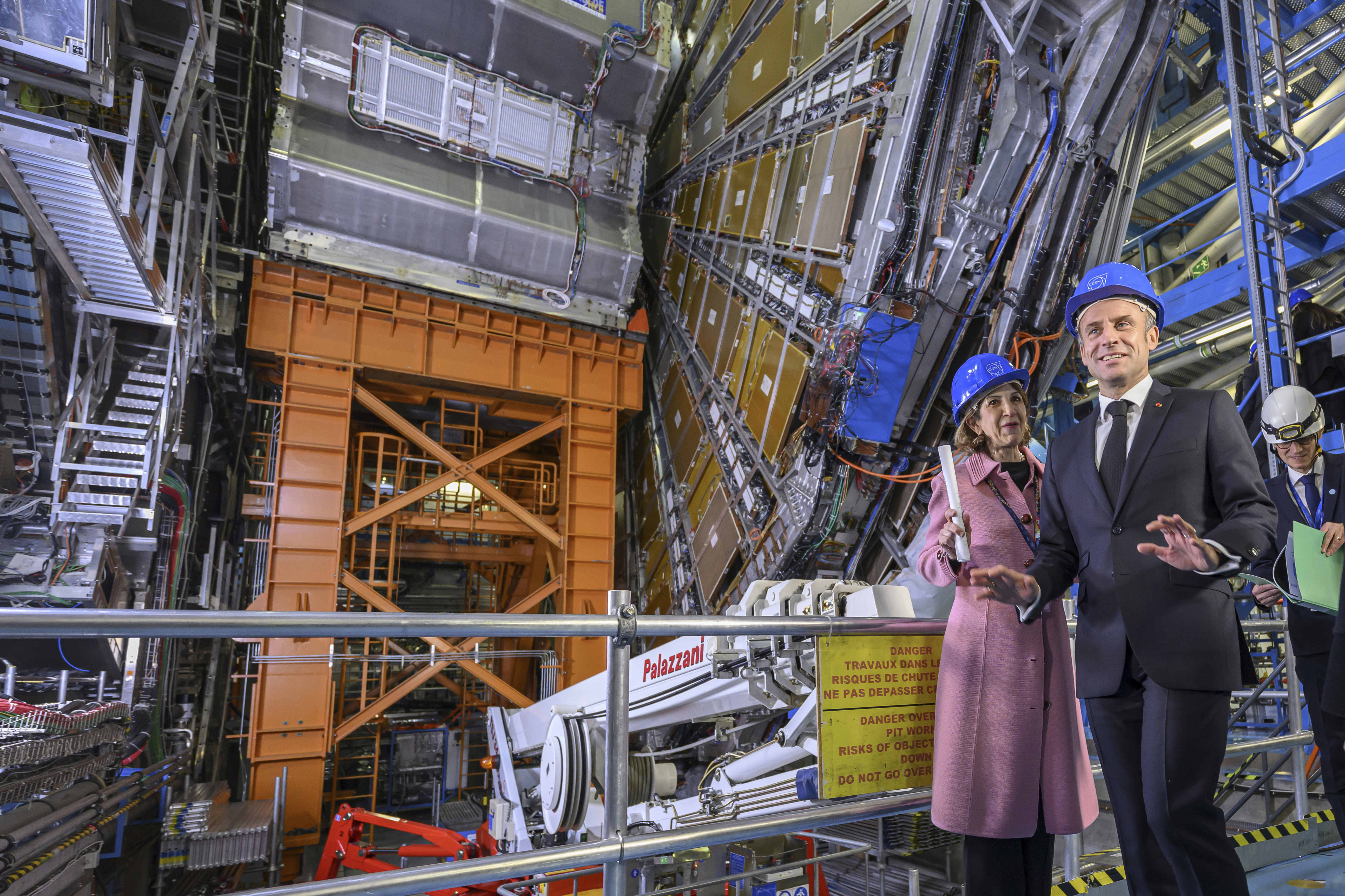 FILE - Fabiola Gianotti, left, Director General of the European Organization for Nuclear Research (CERN), and French President Emmanuel Macron, front, visit the ATLAS experiment, at the CERN (the European particle physics laboratory), in Meyrin near Geneva, Switzerland, Thursday, Nov. 16, 2023. (Martial Trezzini/Keystone via AP, Pool, File)