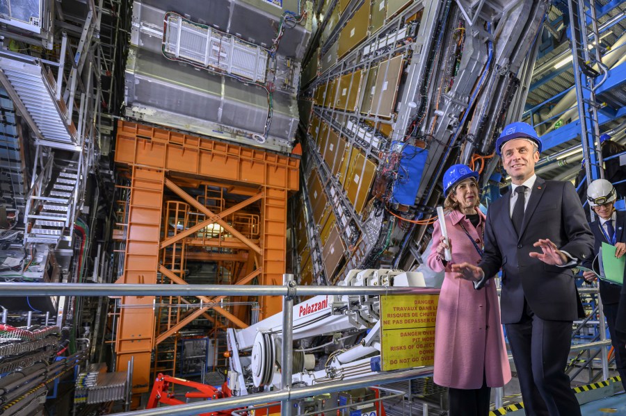 FILE - Fabiola Gianotti, left, Director General of the European Organization for Nuclear Research (CERN), and French President Emmanuel Macron, front, visit the ATLAS experiment, at the CERN (the European particle physics laboratory), in Meyrin near Geneva, Switzerland, Thursday, Nov. 16, 2023. (Martial Trezzini/Keystone via AP, Pool, File)