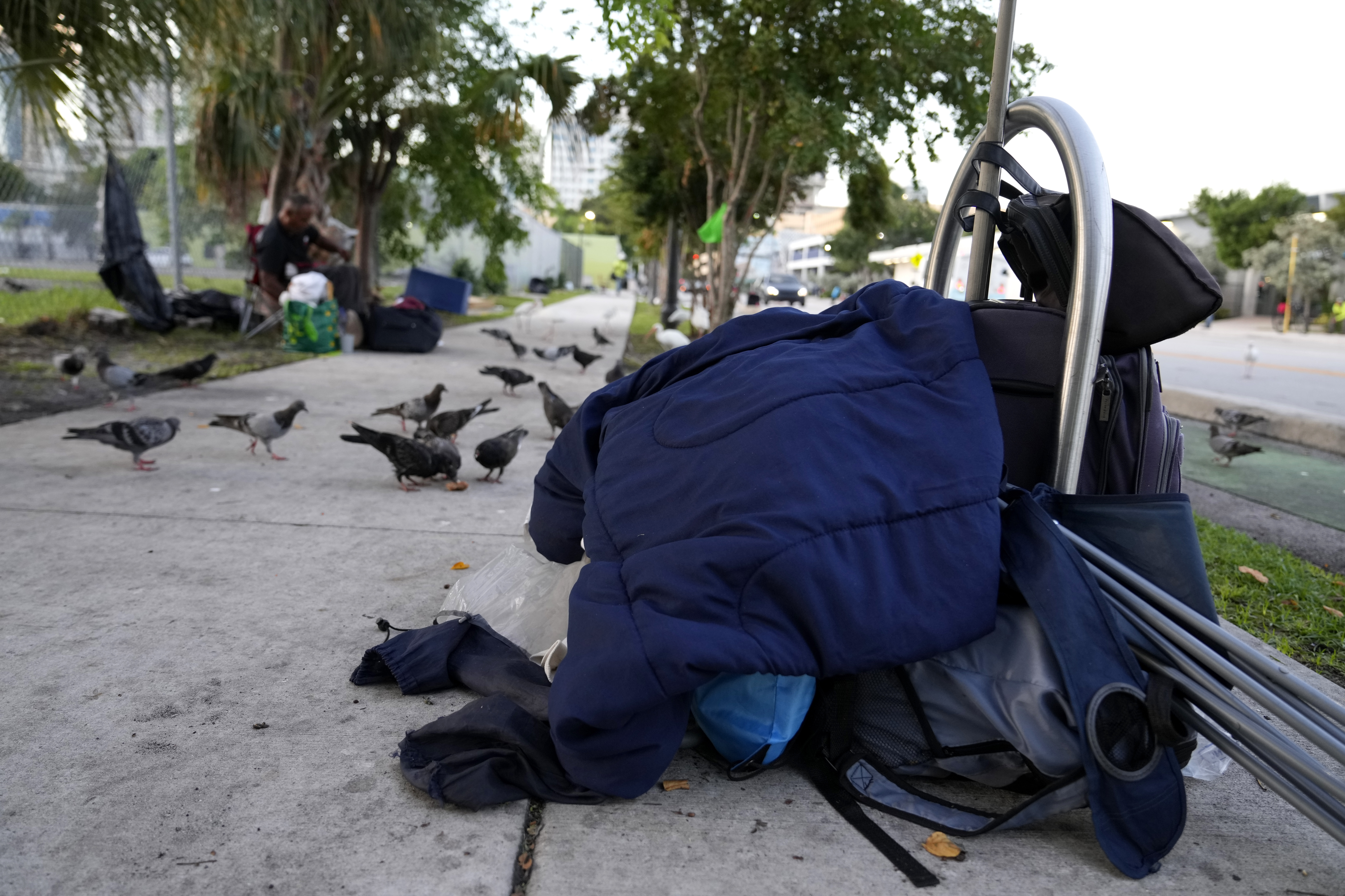 The belongings of a homeless person are piled on the sidewalk on the first day of a statute that took effect, making it illegal in Florida to sleep on sidewalks, in parks, on beaches or in other public spaces — one of the country's strictest anti-homelessness laws, Tuesday, Oct. 1, 2024, in Fort Lauderdale, Fla. (AP Photo/Lynne Sladky)