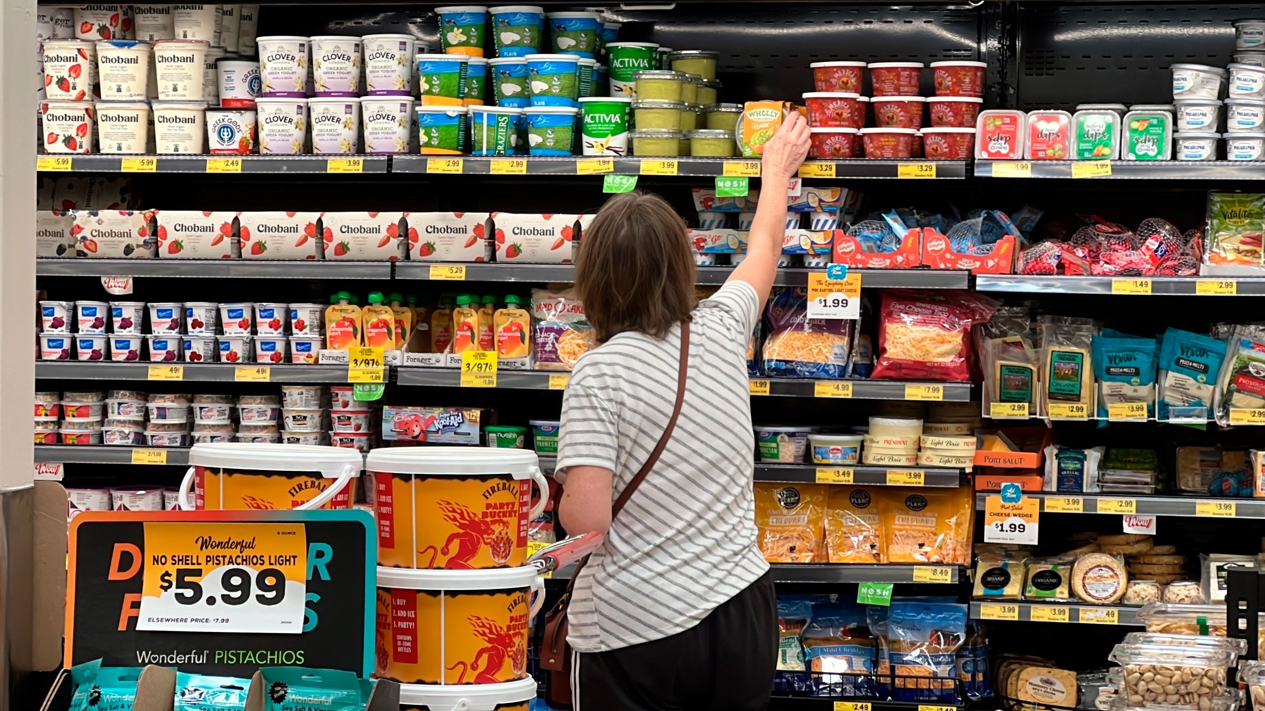 FILE - A customer looks at refrigerated items at a Grocery Outlet store in Pleasanton, Calif., Thursday, Sept. 15, 2022. (AP Photo/Terry Chea, File)