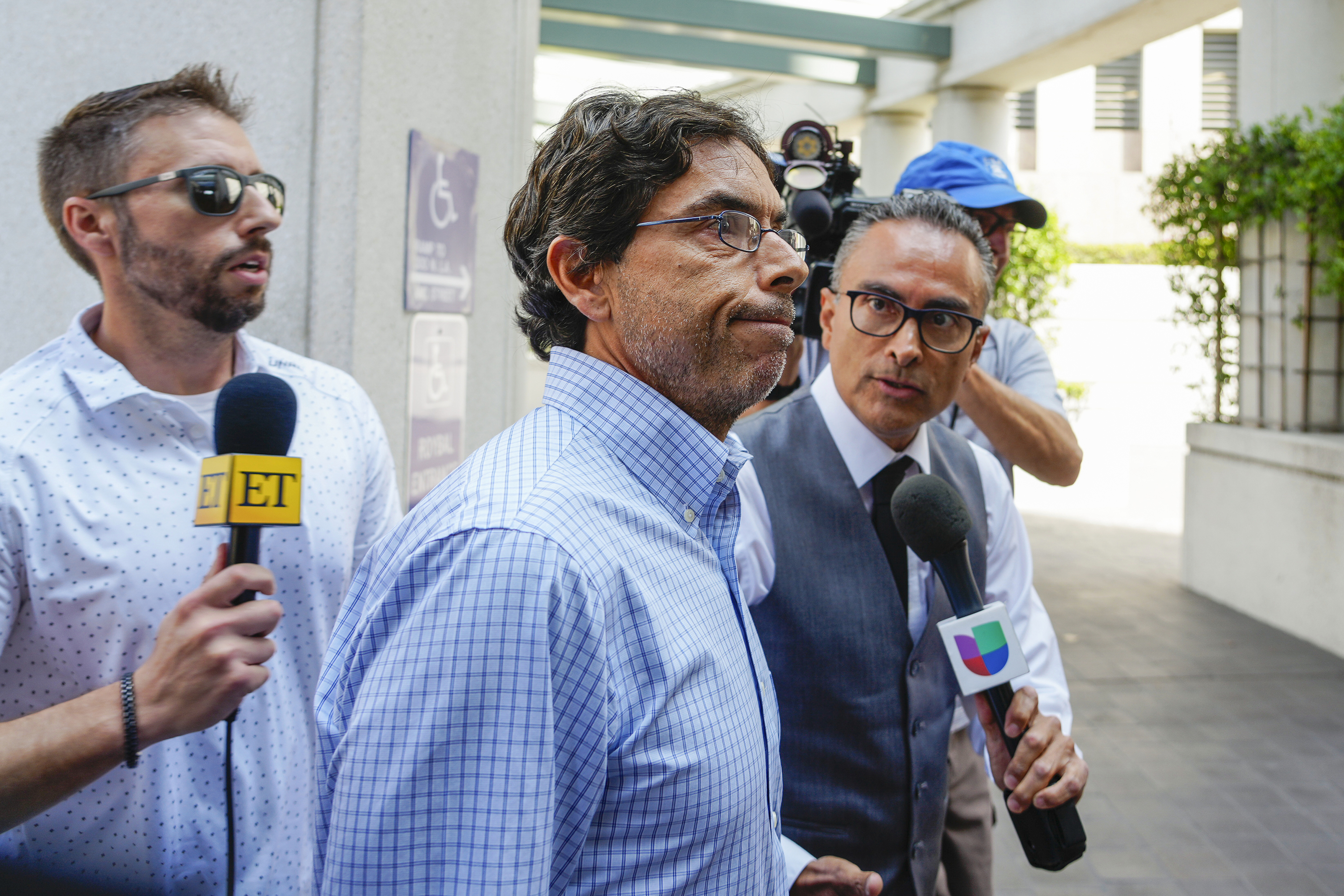 FILE - Dr. Mark Chavez, center, a physician from San Diego, who is charged in connection with actor Matthew Perry's death from an accidental ketamine overdose, arrives at the Roybal Federal Courthouse in Los Angeles, Friday, Aug. 30, 2024. (AP Photo/Damian Dovarganes, File)