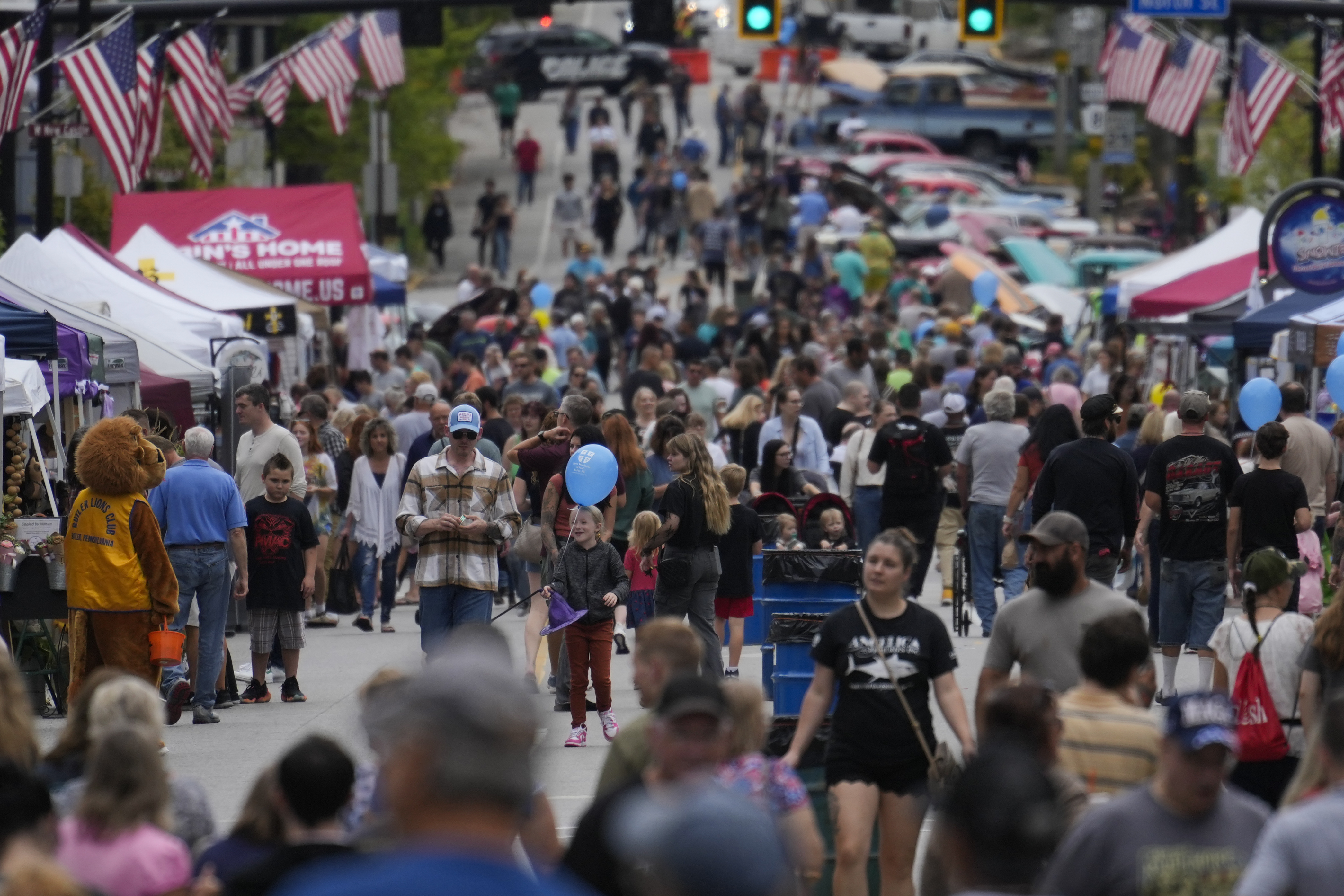 People attend the Butler Fall Festival in Butler, Saturday, Sept. 28, 2024. (AP Photo/Matt Rourke)