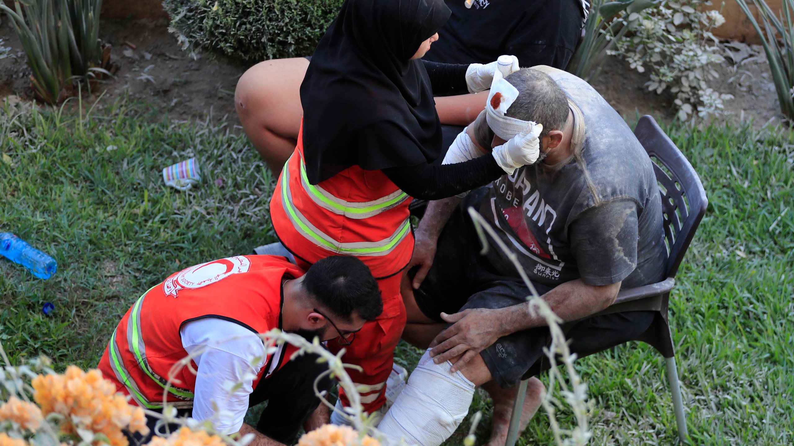 FILE - Paramedics treat a man who was injured after an Israeli airstrike hit two adjacent buildings east of the southern port city of Sidon, Lebanon, Sunday, Sept. 29, 2024. (AP Photo/Mohammed Zaatari, File)