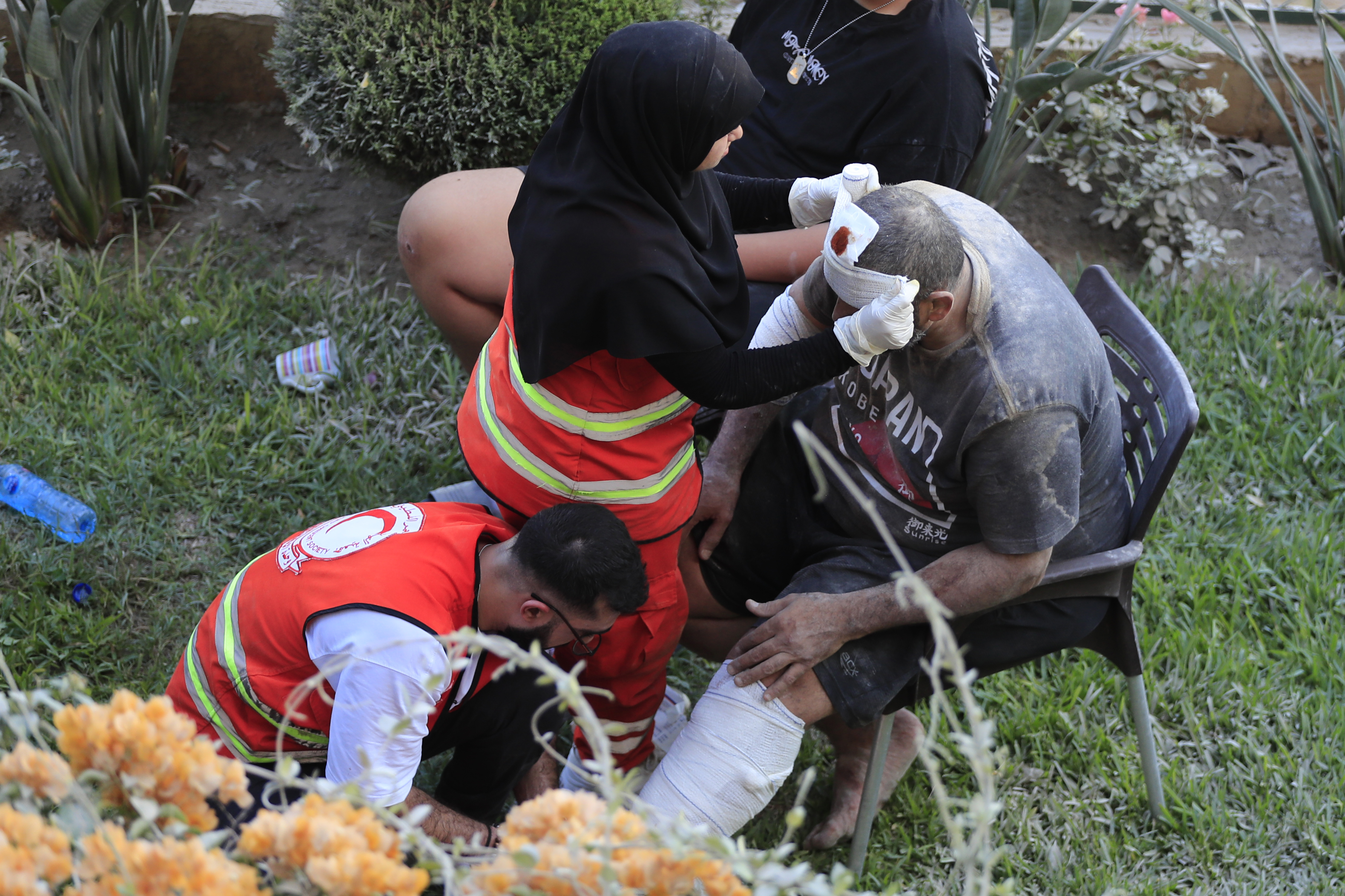 FILE - Paramedics treat a man who was injured after an Israeli airstrike hit two adjacent buildings east of the southern port city of Sidon, Lebanon, Sunday, Sept. 29, 2024. (AP Photo/Mohammed Zaatari, File)