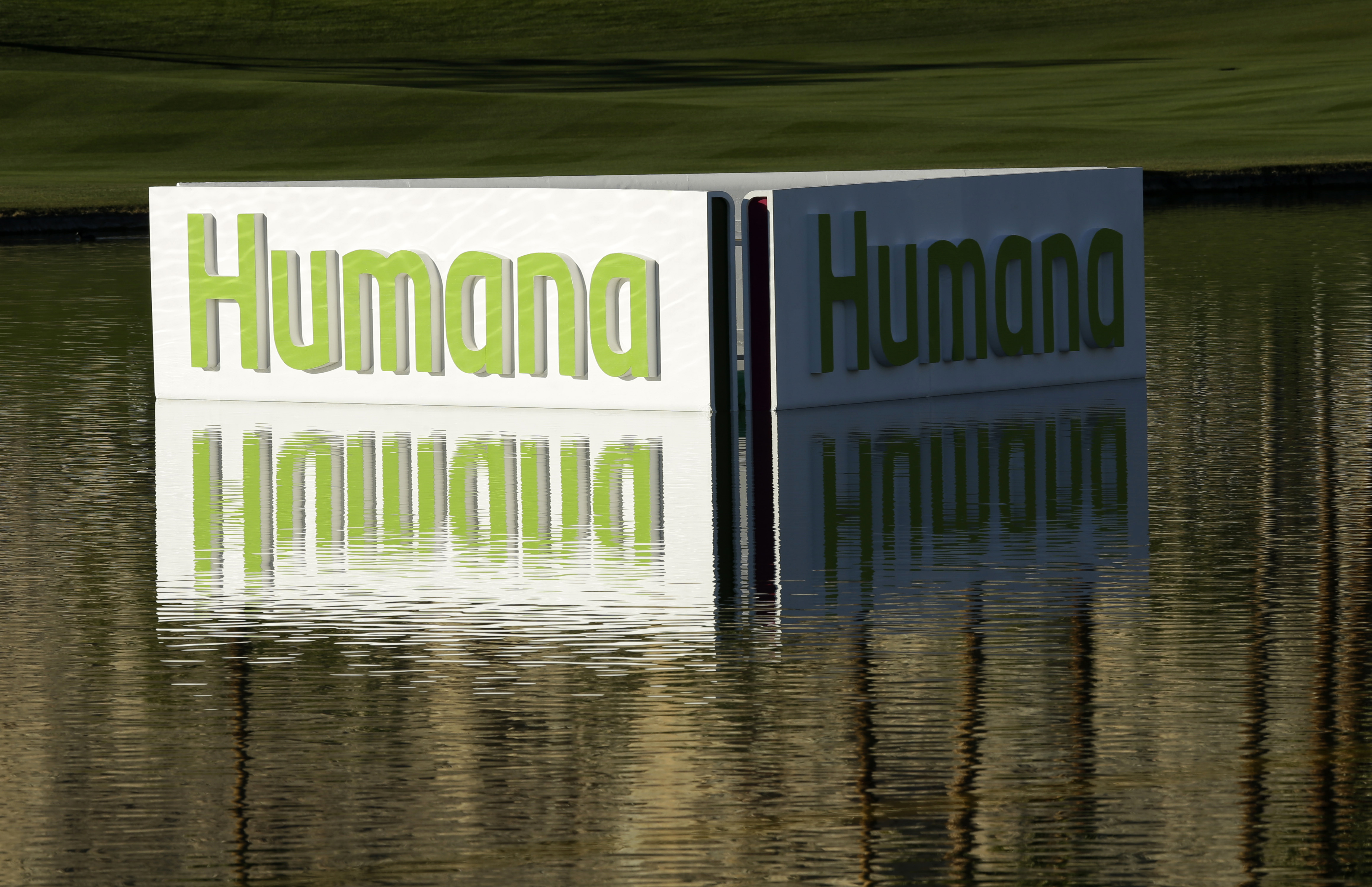 FILE - A Humana logo is seen in a lake on the Palmer Private Course at PGA West during the first round of the Humana Challenge PGA golf tournament in La Quinta, Calif., Jan. 17, 2013. (AP Photo/Ben Margot, File)