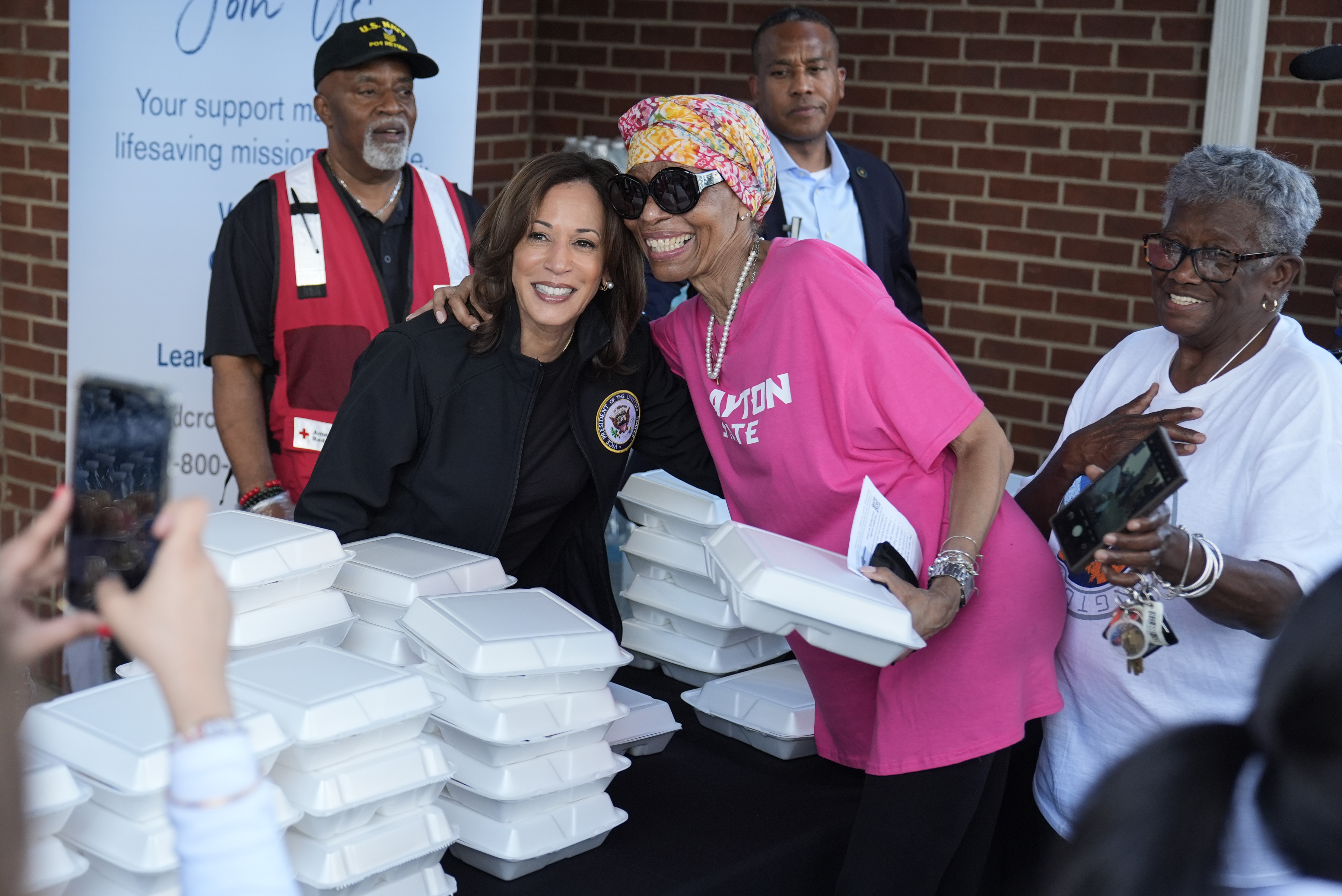 Democratic presidential nominee Vice President Kamala Harris poses for a photo as she helps distribute food with the American Red Cross at the Henry Brigham Community Center in Augusta, Ga., Wednesday, Oct. 2, 2024. (AP Photo/Carolyn Kaster)