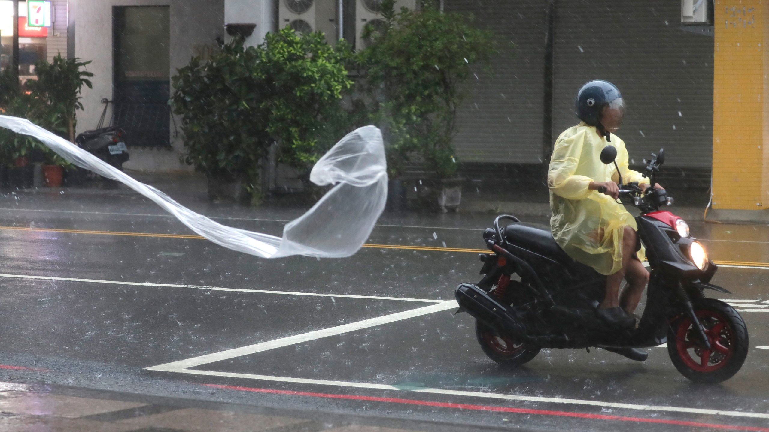 A man rides in the wind and rain generated by Typhoon Krathon in Kaohsiung, southern Taiwan, Thursday, Oct. 3, 2024. (AP Photo/Chiang Ying-ying)