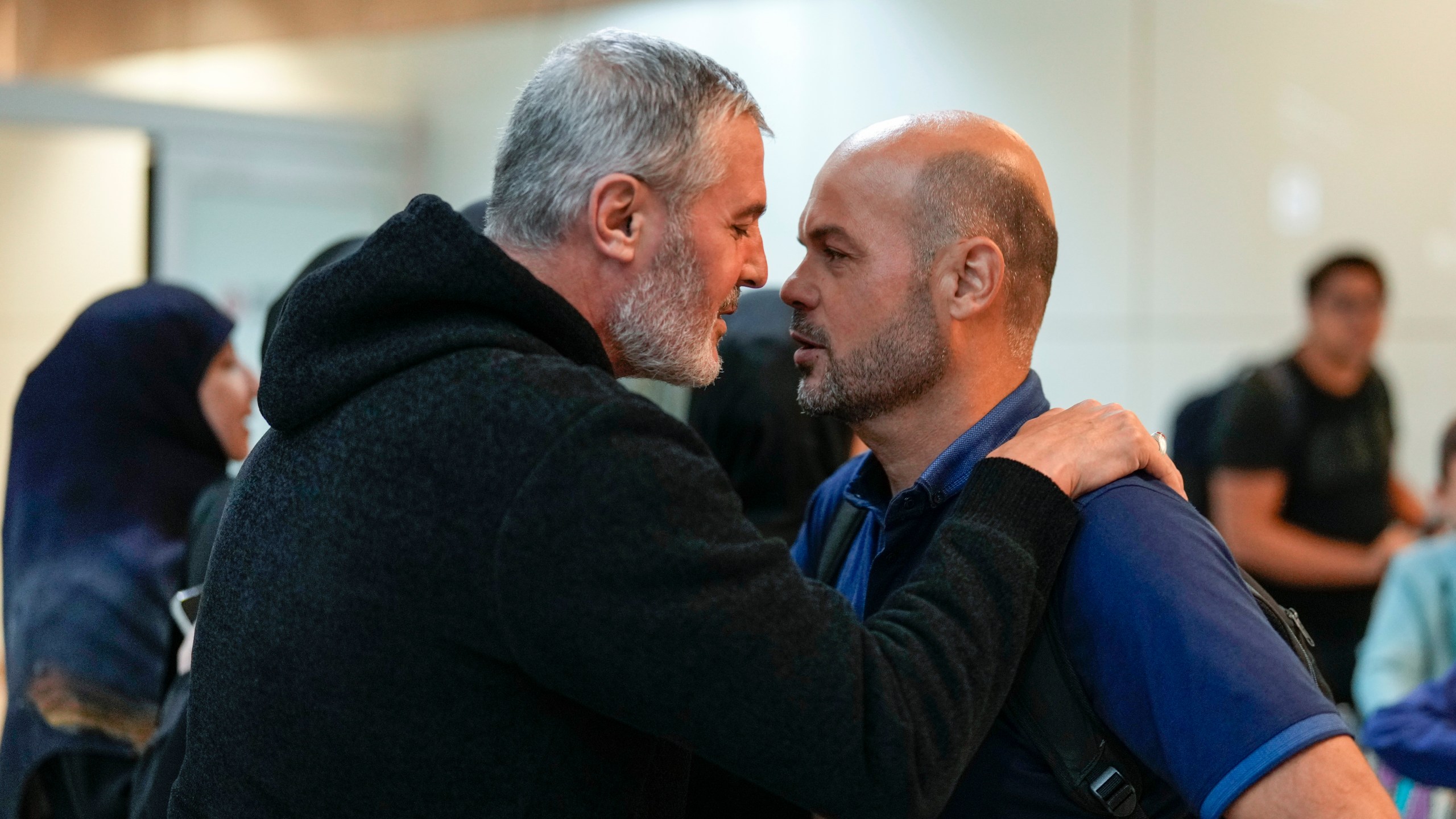 Lebanese citizen Ali Zeineddine, left, greets his brother Hussein arriving from Lebanon, after an Israeli air strike killed various members of their family, at Sao Paulo International airport, Thursday, Oct. 3, 2024. (AP Photo/Andre Penner)