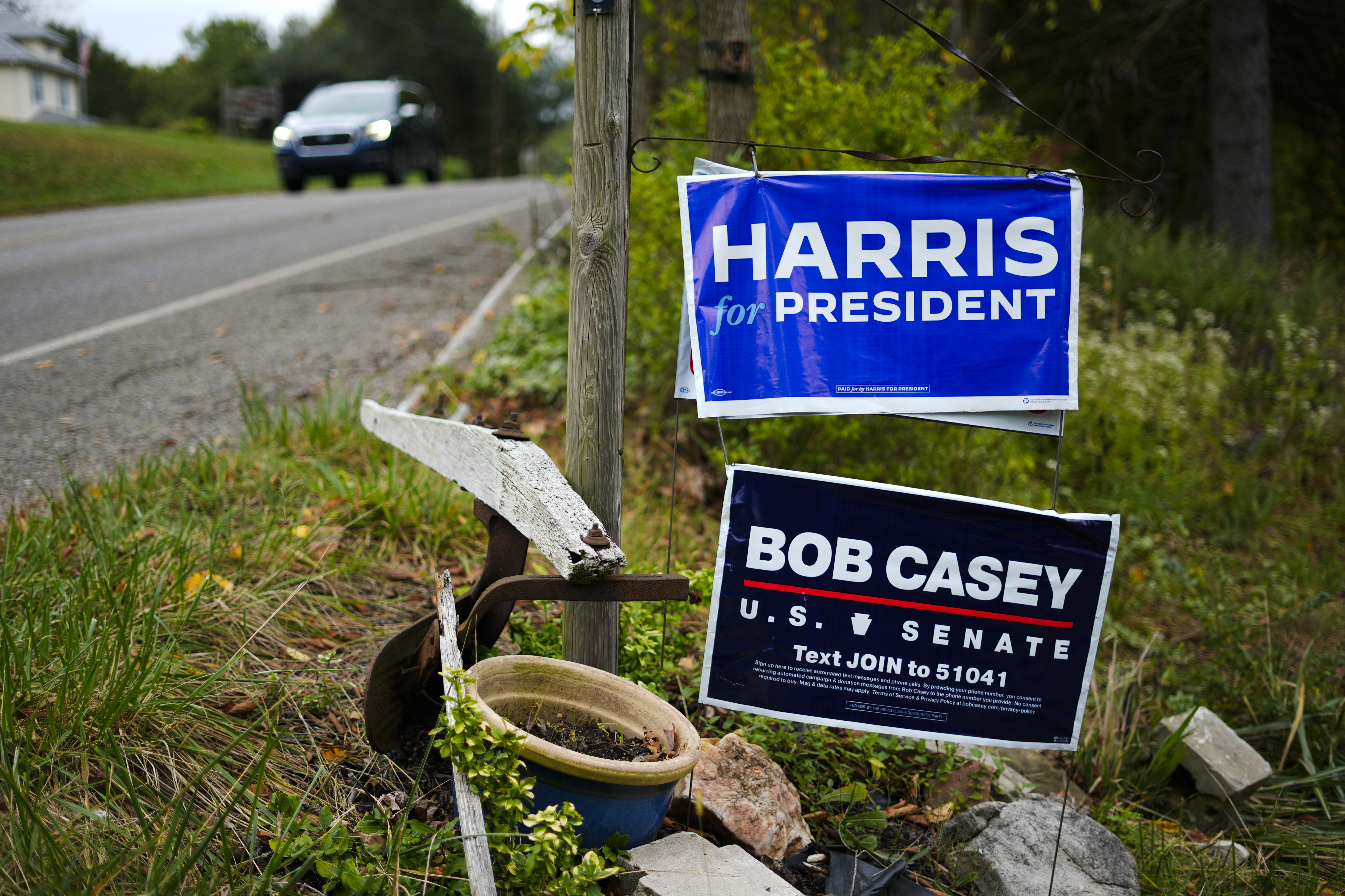 A car passes signs supporting Democratic presidential nominee Vice President Kamala Harris and Sen. Bob Casey, D-Pa., in Butler, Friday, Sept. 27, 2024. (AP Photo/Matt Rourke)