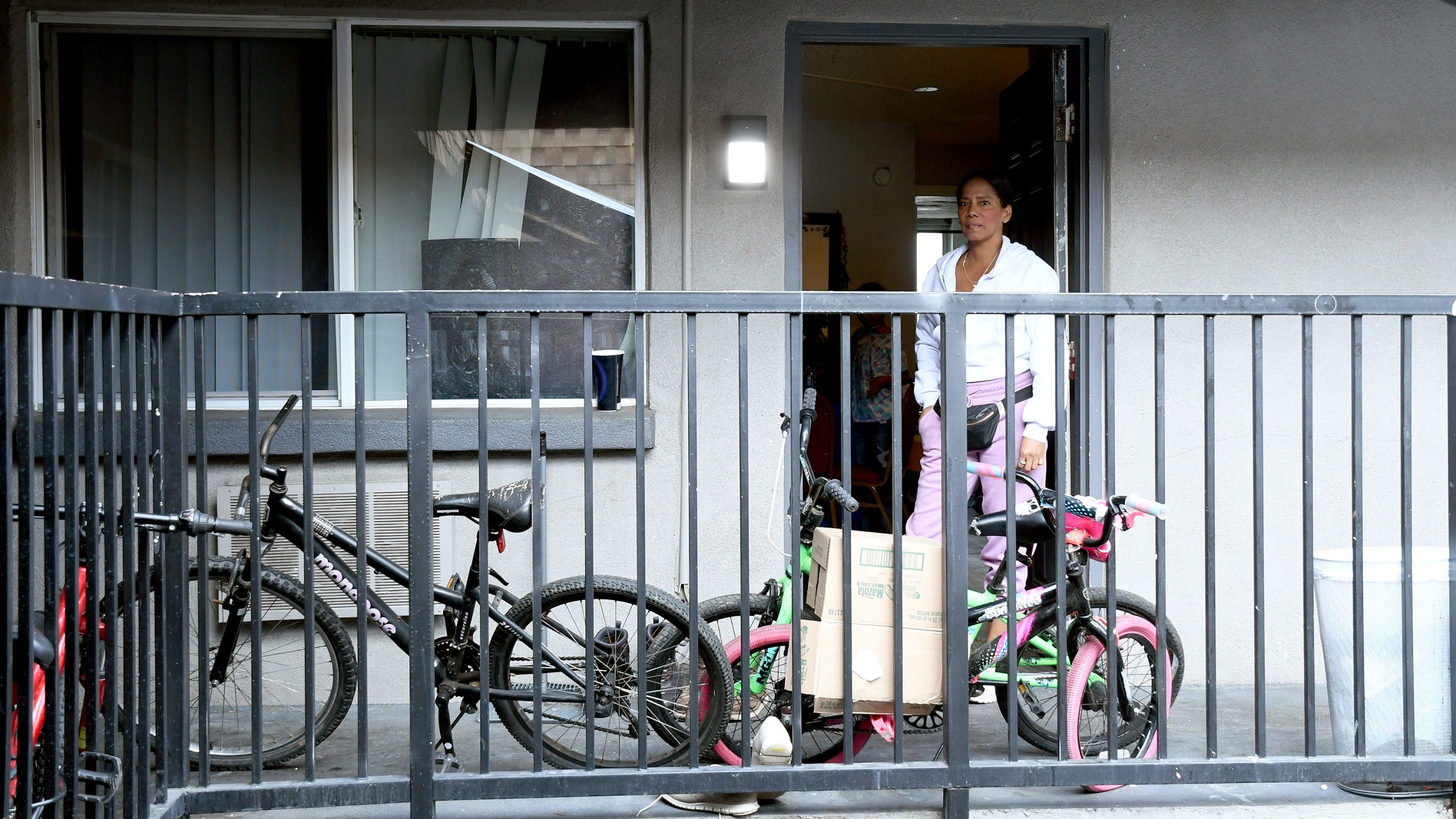 Sofia Roca stands at the entry to her apartment in in Aurora, Colorado, on March 29, 2024. In the U.S., she realizes reports she’d heard back in Colombia about earning $1,000 a week were likely hyperbole. (AP Photo/Thomas Peipert)