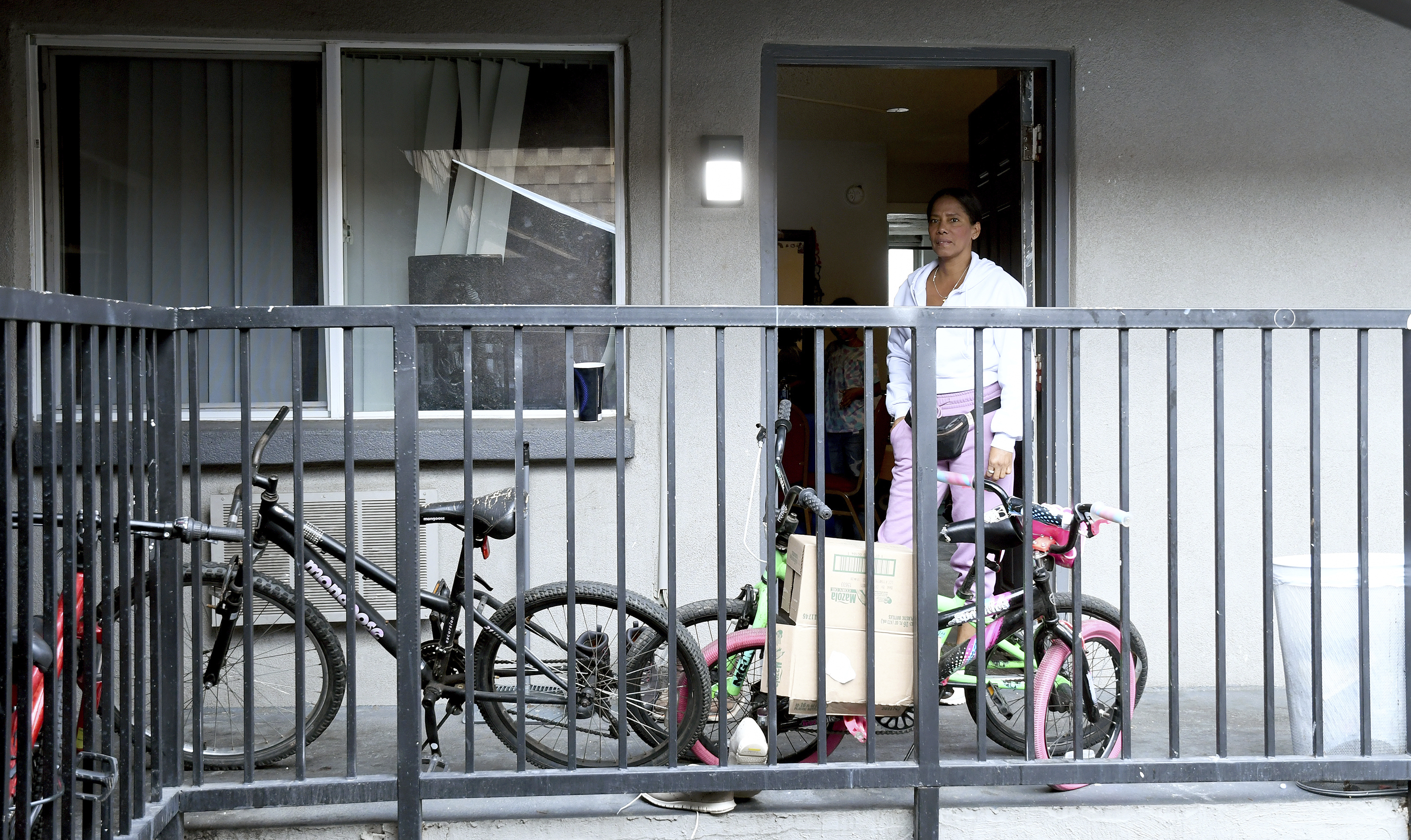 Sofia Roca stands at the entry to her apartment in in Aurora, Colorado, on March 29, 2024. In the U.S., she realizes reports she’d heard back in Colombia about earning $1,000 a week were likely hyperbole. (AP Photo/Thomas Peipert)