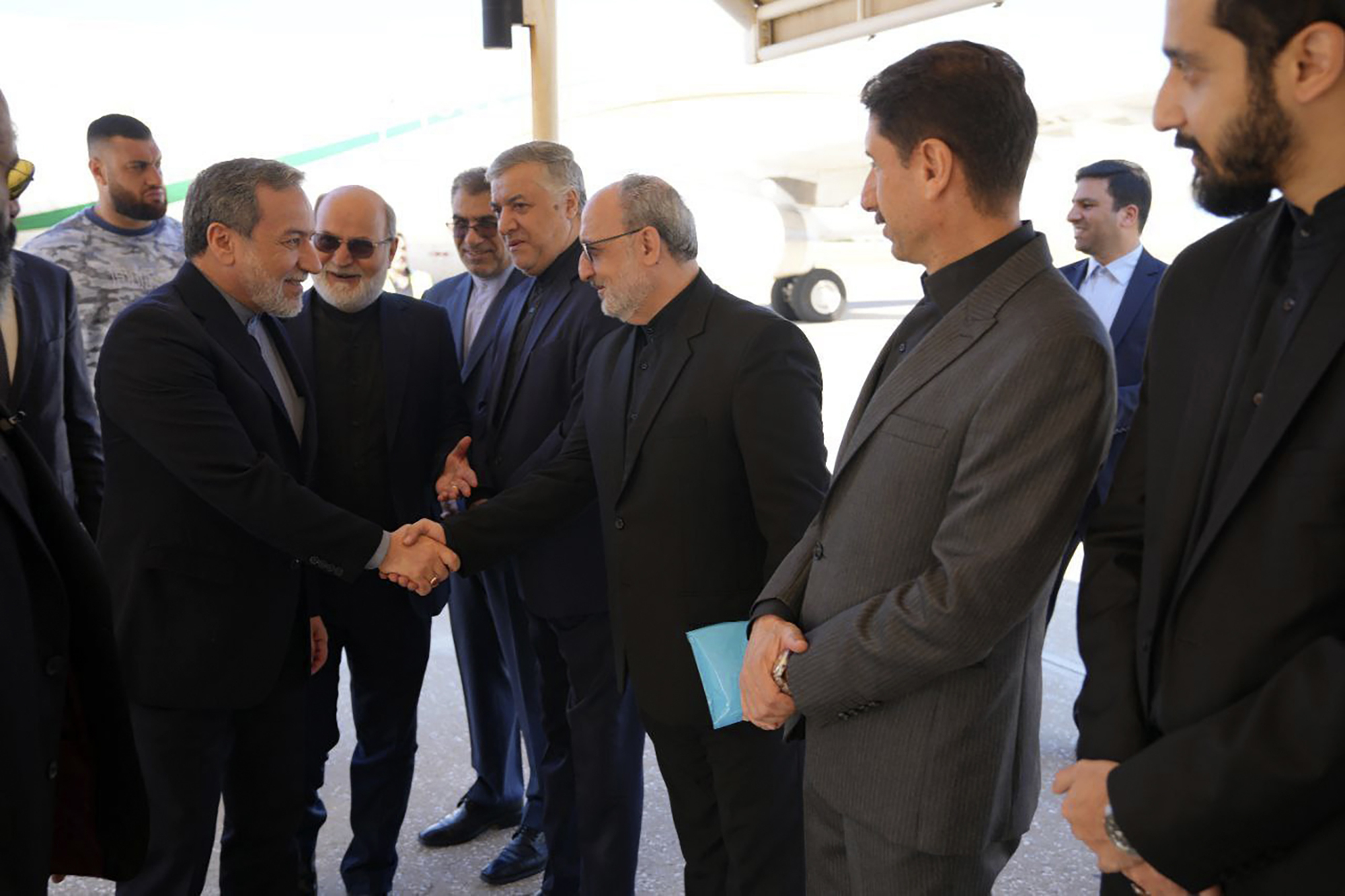 In this photo released by Iranian Foreign Ministry, Foreign Minister Abbas Araghchi, left, is welcomed by a group of officials upon arrival at Beirut, Lebanon, Friday, Oct. 4, 2024. (Iranian Foreign Ministry via AP)