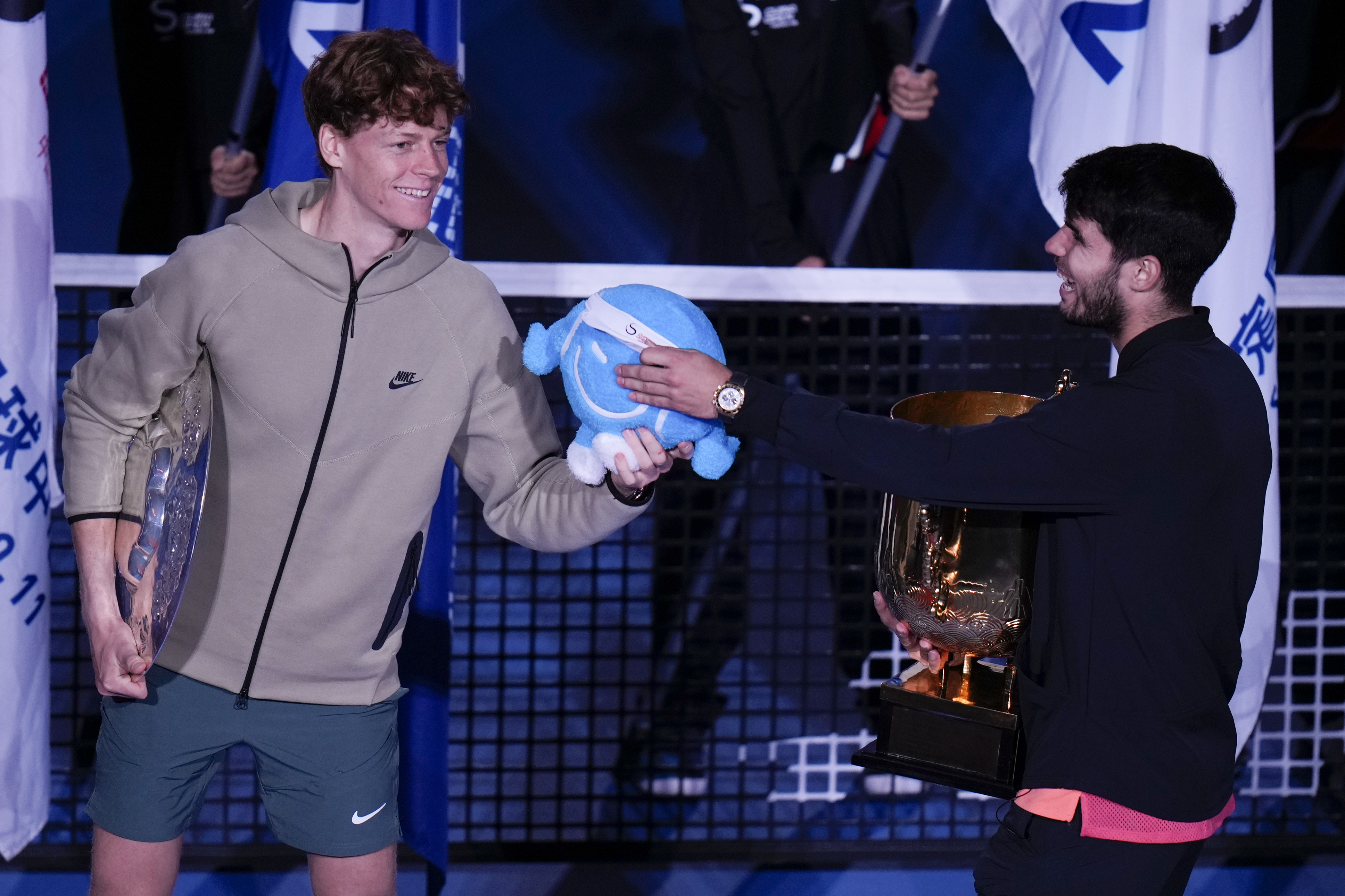 Carlos Alcaraz, right, of Spain talks with runner-up Jannik Sinner of Italy after winning their men's singles finals match of the China Open tennis tournament, at the National Tennis Center in Beijing, Wednesday, Oct. 2, 2024.(AP Photo/Andy Wong)