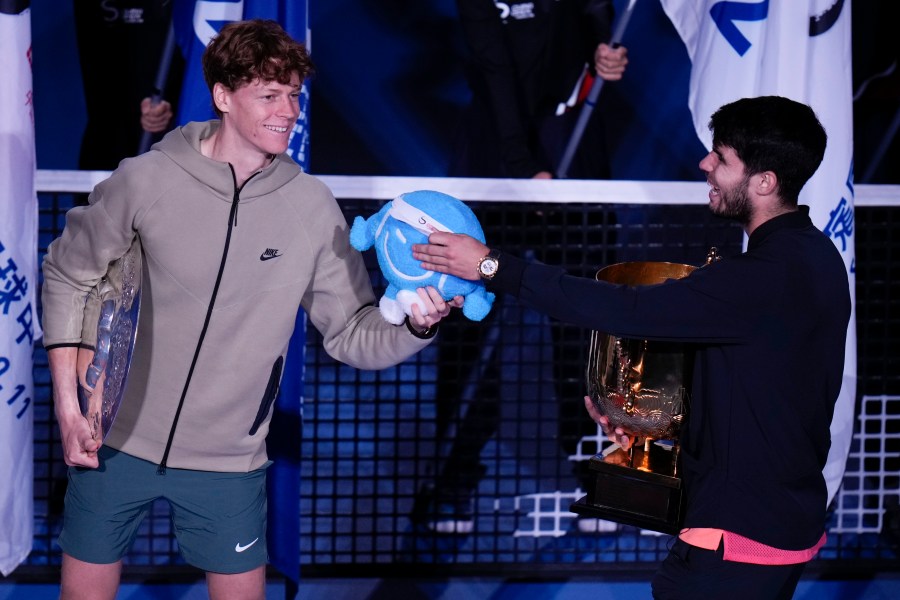 Carlos Alcaraz, right, of Spain talks with runner-up Jannik Sinner of Italy after winning their men's singles finals match of the China Open tennis tournament, at the National Tennis Center in Beijing, Wednesday, Oct. 2, 2024.(AP Photo/Andy Wong)