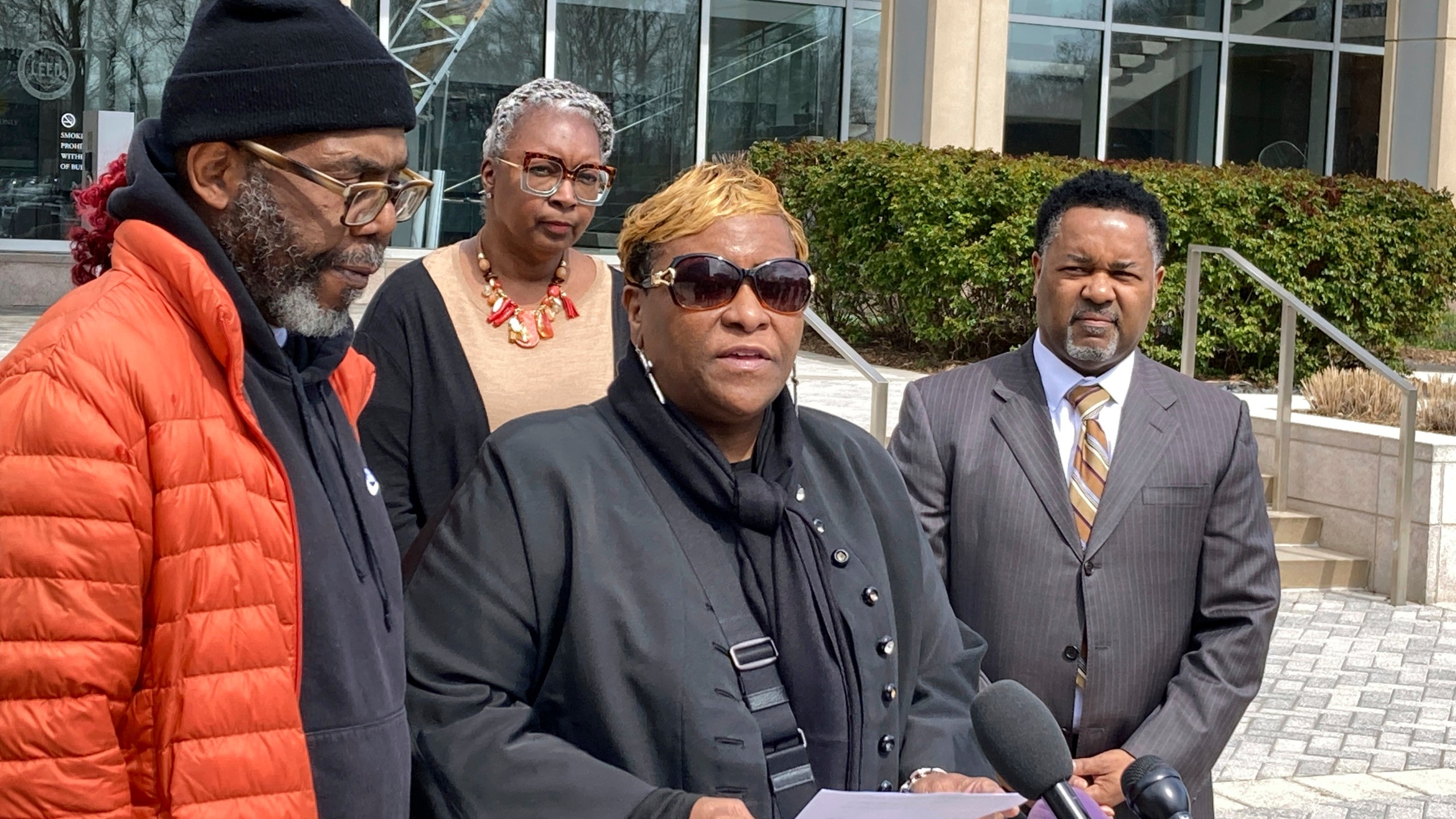 FILE - Timothy McCree Johnson's parents Melissa Johnson, center, and Timothy Walker, left, address reporters along with attorney Carl Crews, right, outside Fairfax County Police headquarters, March 22, 2023, in Fairfax, Va. (AP Photo/Matthew Barakat, File)