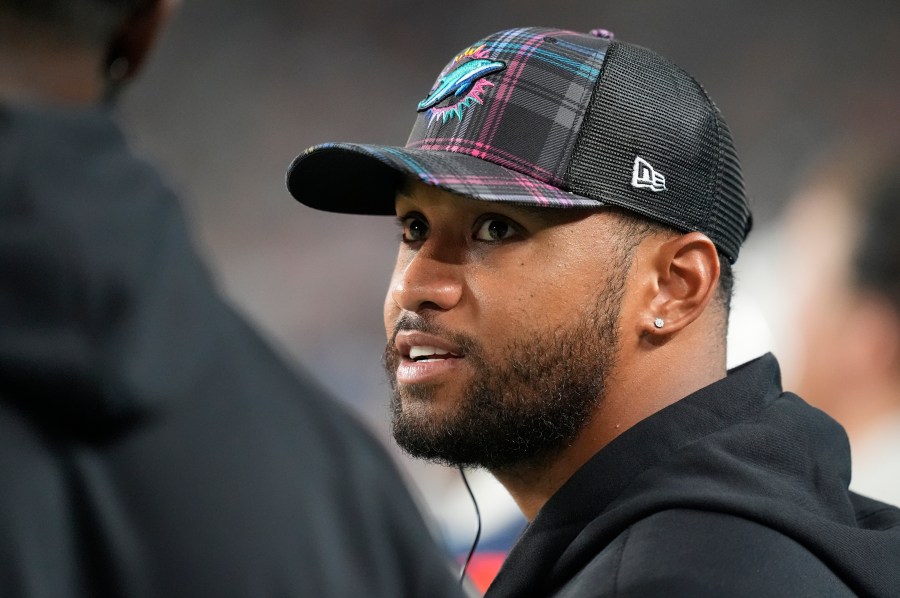 Miami Dolphins quarterback Tua Tagovailoa talks on the sidelines during the second half of an NFL football game against the Tennessee Titans, Monday, Sept. 30, 2024, in Miami Gardens, Fla. (AP Photo/Rebecca Blackwell)