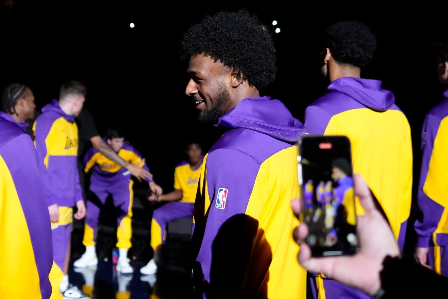 Los Angeles Lakers guard Bronny James stands on the court during introductions prior to a preseason NBA basketball game against the Minnesota Timberwolves, Friday, Oct. 4, 2024, in Palm Desert, Calif. (AP Photo/Mark J. Terrill)