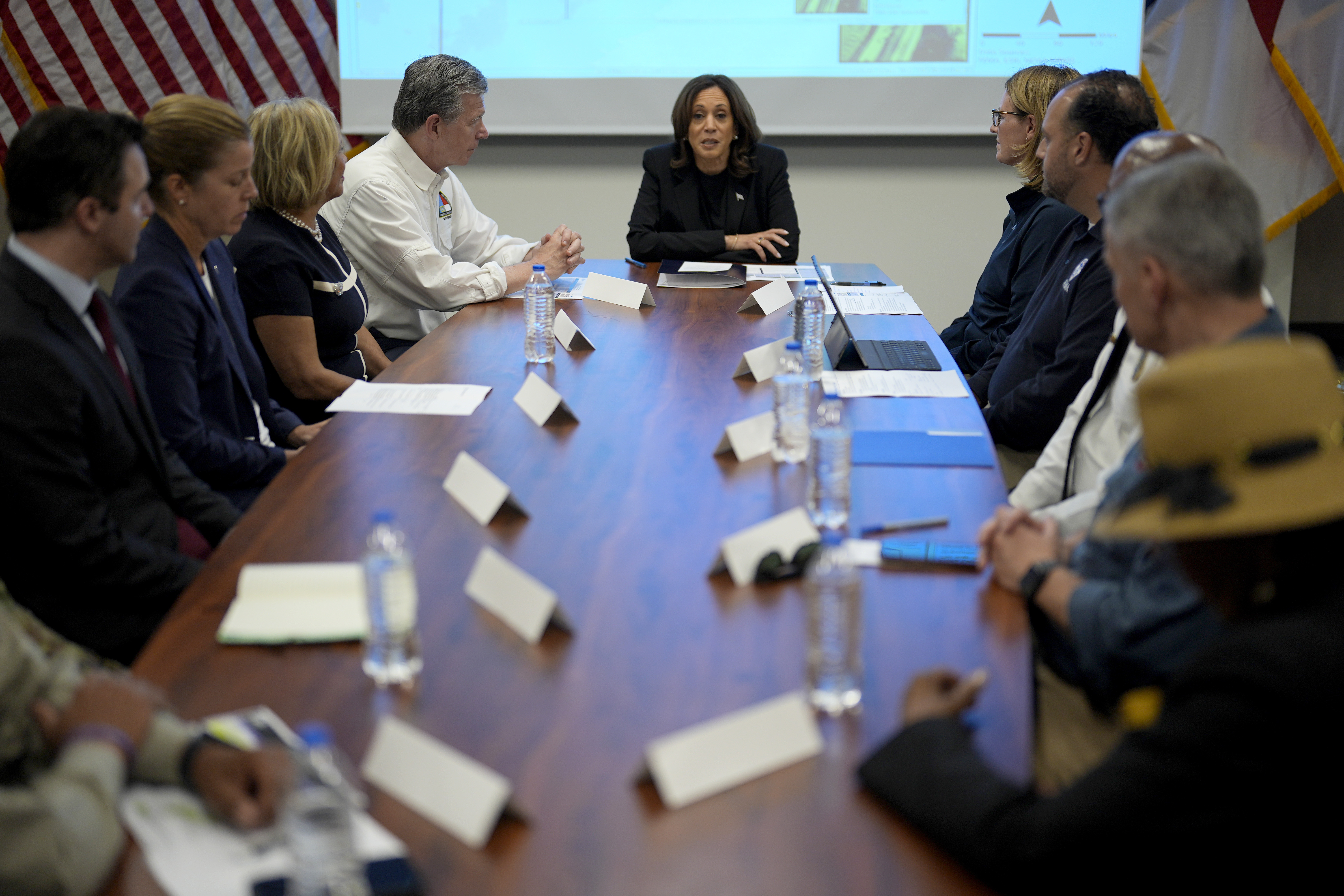 Democratic presidential nominee Vice President Kamala Harris, center right, receives a briefing from North Carolina Gov. Roy Cooper, center left, on the damage from Hurricane Helene, Saturday, October 5, 2024, in Charlotte, N.C. (AP Photo/Chris Carlson)