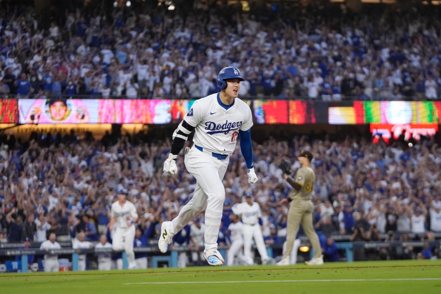 Los Angeles Dodgers' Shohei Ohtani reacts as he rounds first base following his three-run home run during the second inning in Game 1 of baseball's NL Division Series against the San Diego Padres, Saturday, Oct. 5, 2024, in Los Angeles. (AP Photo/Mark J. Terrill)