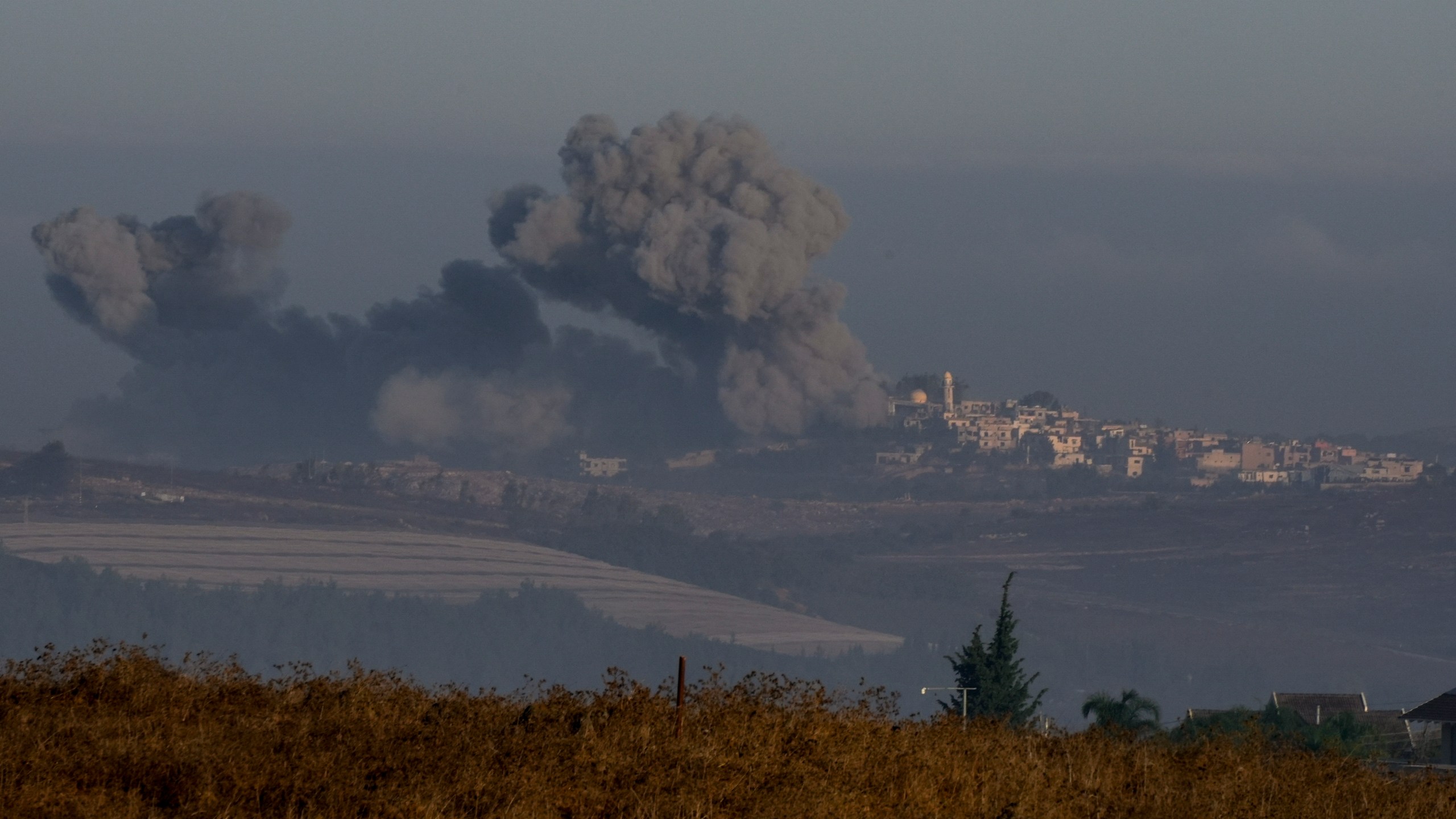 Smoke rises following Israeli bombardment in southern Lebanon as seen from northern Israel, Sunday, Oct. 6, 2024. (AP Photo/Baz Ratner)