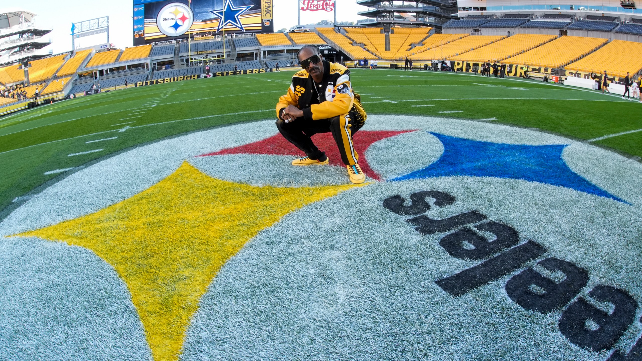 Snoop Dogg poses for photos prior to an NFL football game between the Pittsburgh Steelers and the Dallas Cowboys, Sunday, Oct. 6, 2024, in Pittsburgh. (AP Photo/Gene J. Puskar)