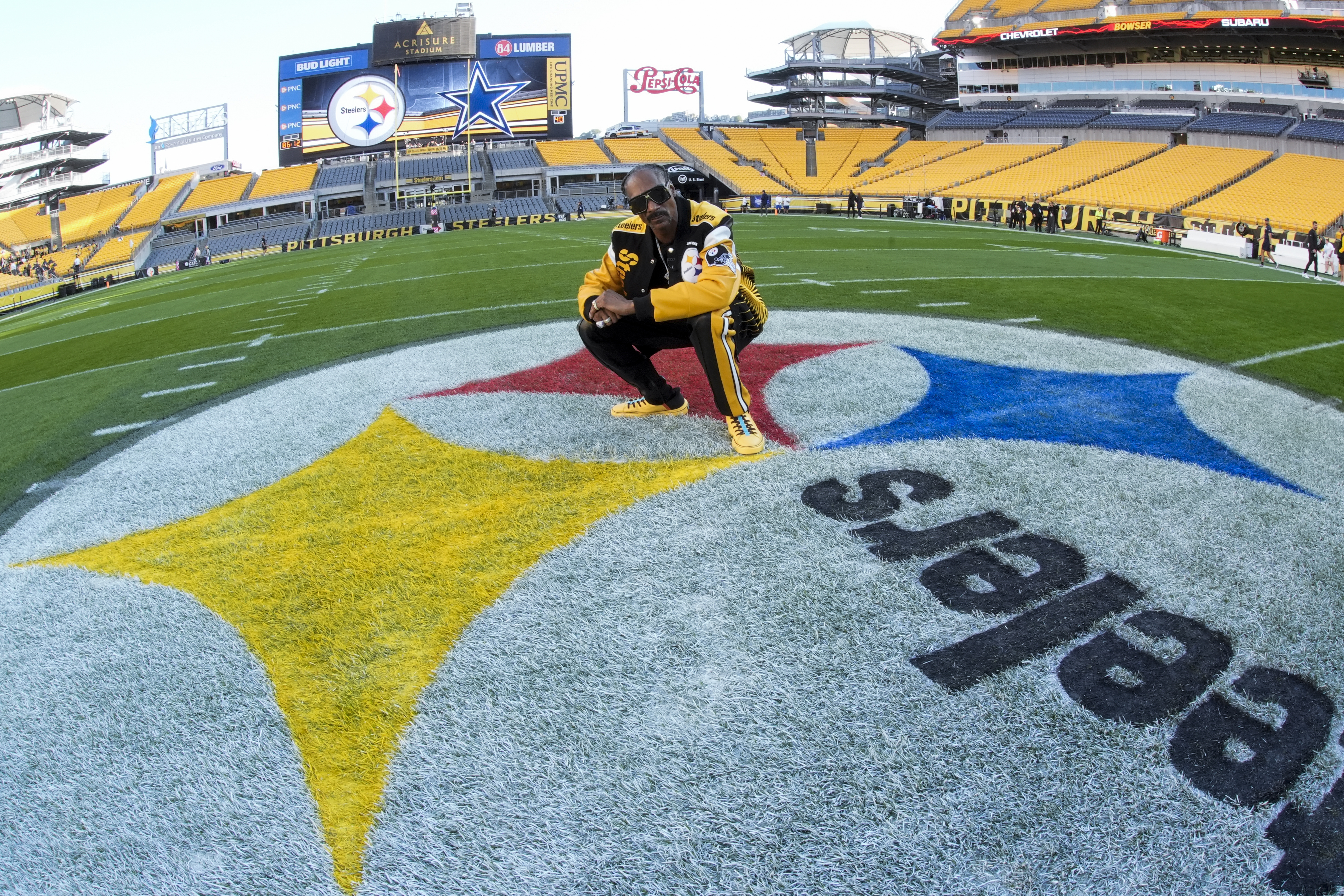 Snoop Dogg poses for photos prior to an NFL football game between the Pittsburgh Steelers and the Dallas Cowboys, Sunday, Oct. 6, 2024, in Pittsburgh. (AP Photo/Gene J. Puskar)