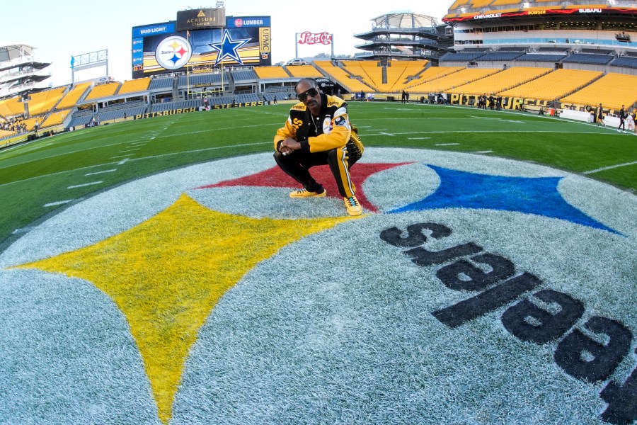 Snoop Dogg poses for photos prior to an NFL football game between the Pittsburgh Steelers and the Dallas Cowboys, Sunday, Oct. 6, 2024, in Pittsburgh. (AP Photo/Gene J. Puskar)