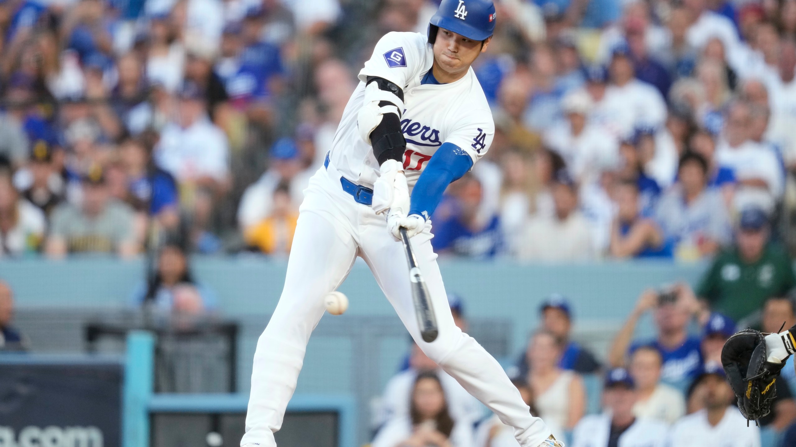 Los Angeles Dodgers' Shohei Ohtani grounds out during the third inning in Game 2 of a baseball NL Division Series against the San Diego Padres, Sunday, Oct. 6, 2024, in Los Angeles. (AP Photo/Ashley Landis)