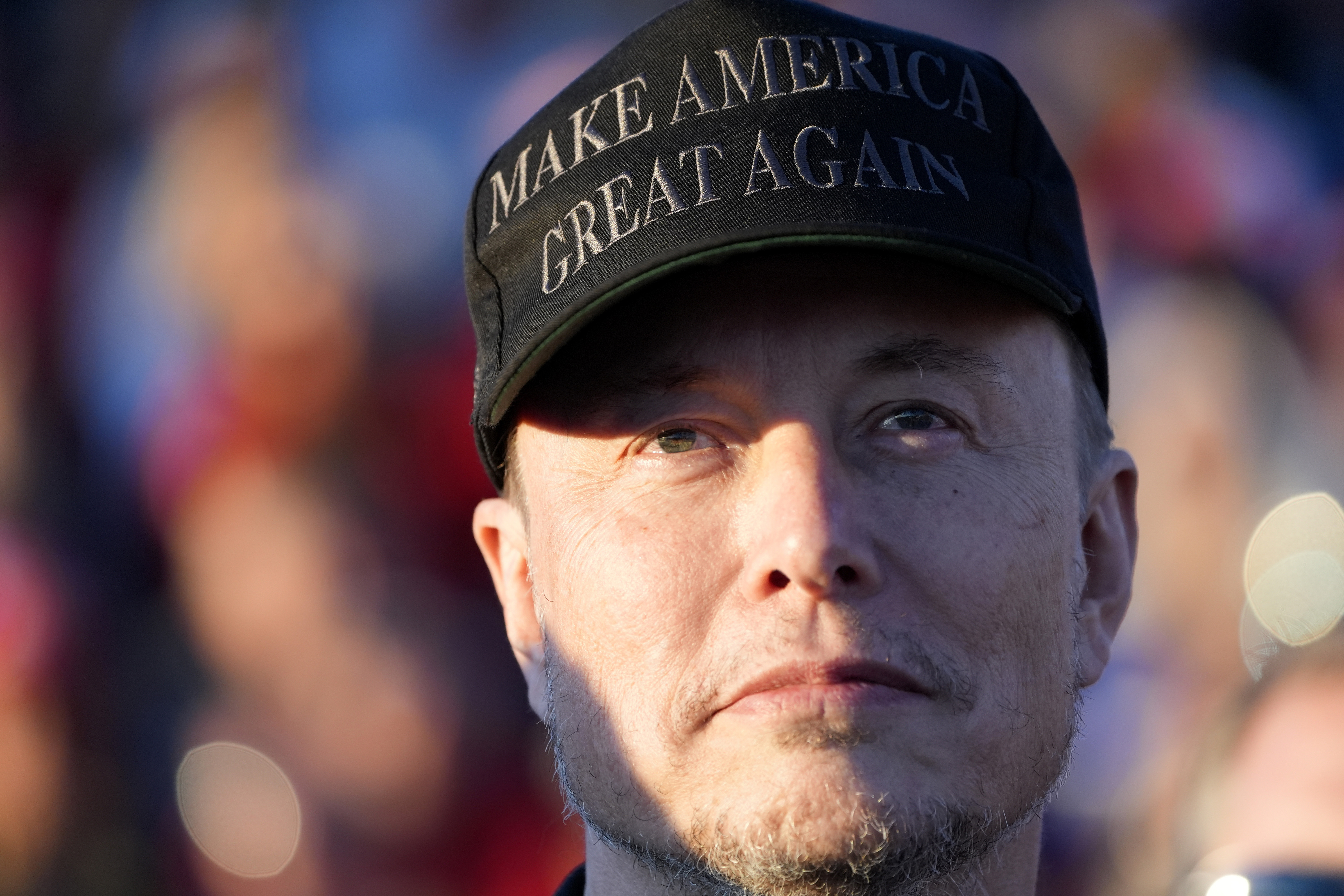 Tesla and SpaceX CEO Elon Musk listens as Republican presidential nominee former President Donald Trump speaks at a campaign event at the Butler Farm Show, Saturday, Oct. 5, 2024, in Butler, Pa. (AP Photo/Alex Brandon)