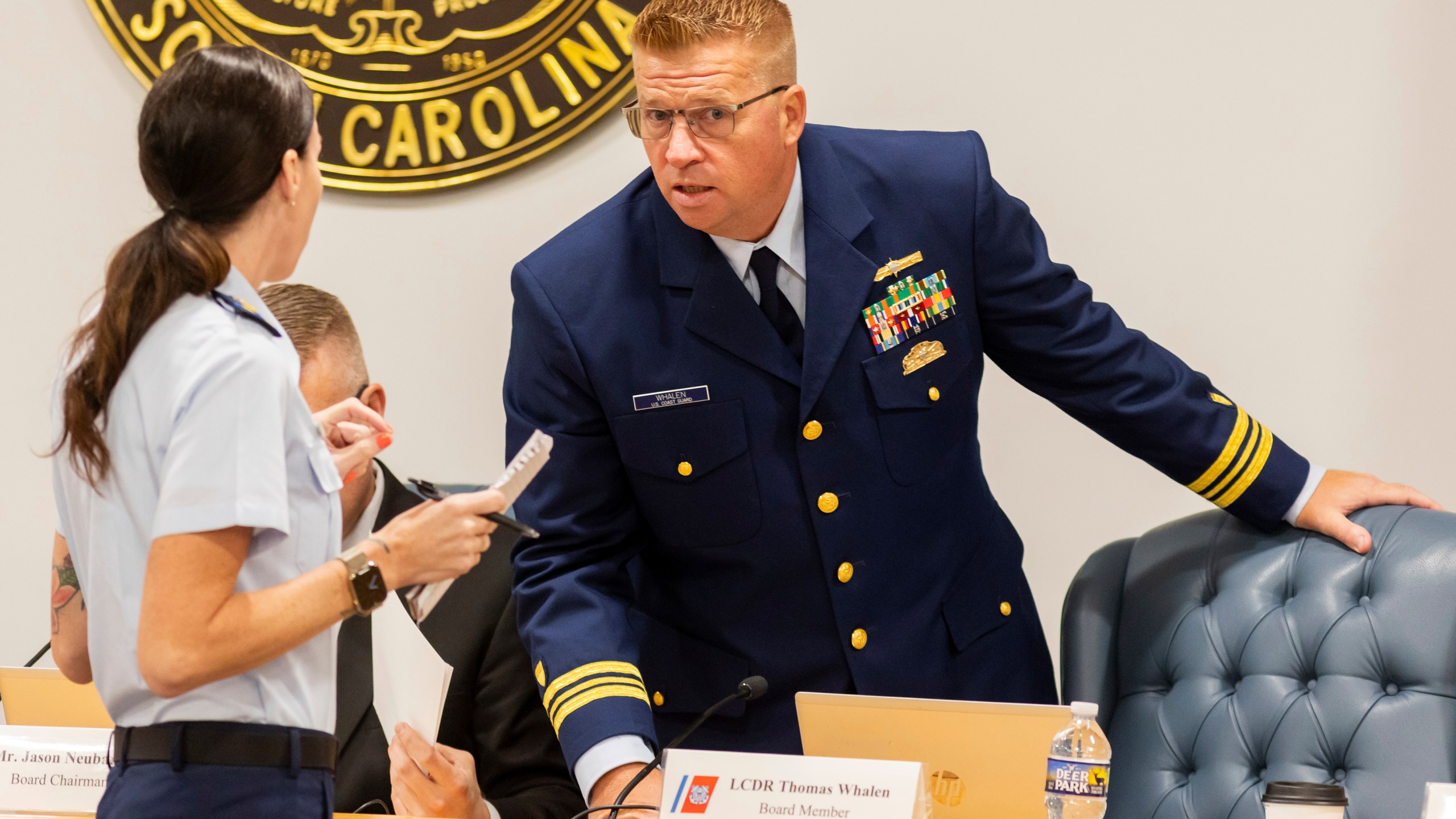 Coast Guard's Thomas Whalen speaks with another Coast Guard member during a break for the Titan marine board formal hearing inside the Charleston County Council Chambers, Monday, Sept. 16, 2024, in North Charleston, S.C. (AP Photo/Mic Smith)