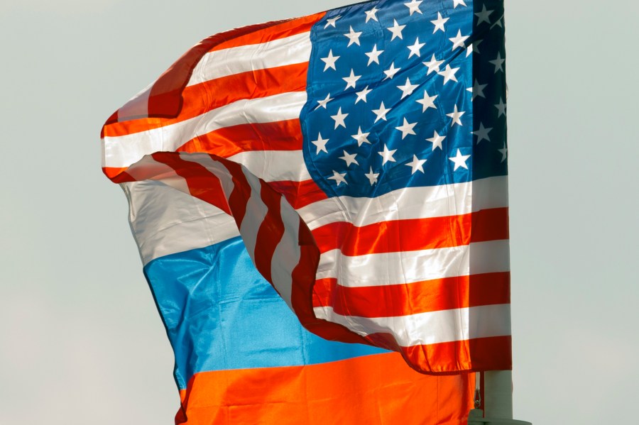 FILE - U.S. and Russian national flags wave on the wind in Moscow's Vnukovo airport, Russia, April 11, 2017 to welcome a U.S. dignitary. (AP Photo/ Ivan Sekretarev, file)