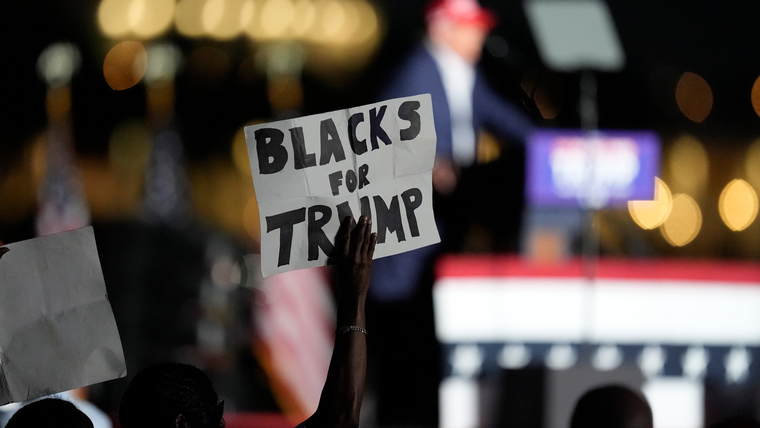 FILE - A supporter holds up a sign as Republican presidential candidate former President Donald Trump speaks at a campaign rally at Trump National Doral Miami, July 9, 2024, in Doral, Fla. (AP Photo/Rebecca Blackwell, File)