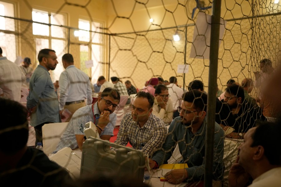 Election officers count votes for the recent election at a counting center in Jammu, India, Tuesday, Oct. 8, 2024. (AP Photo/Channi Anand)