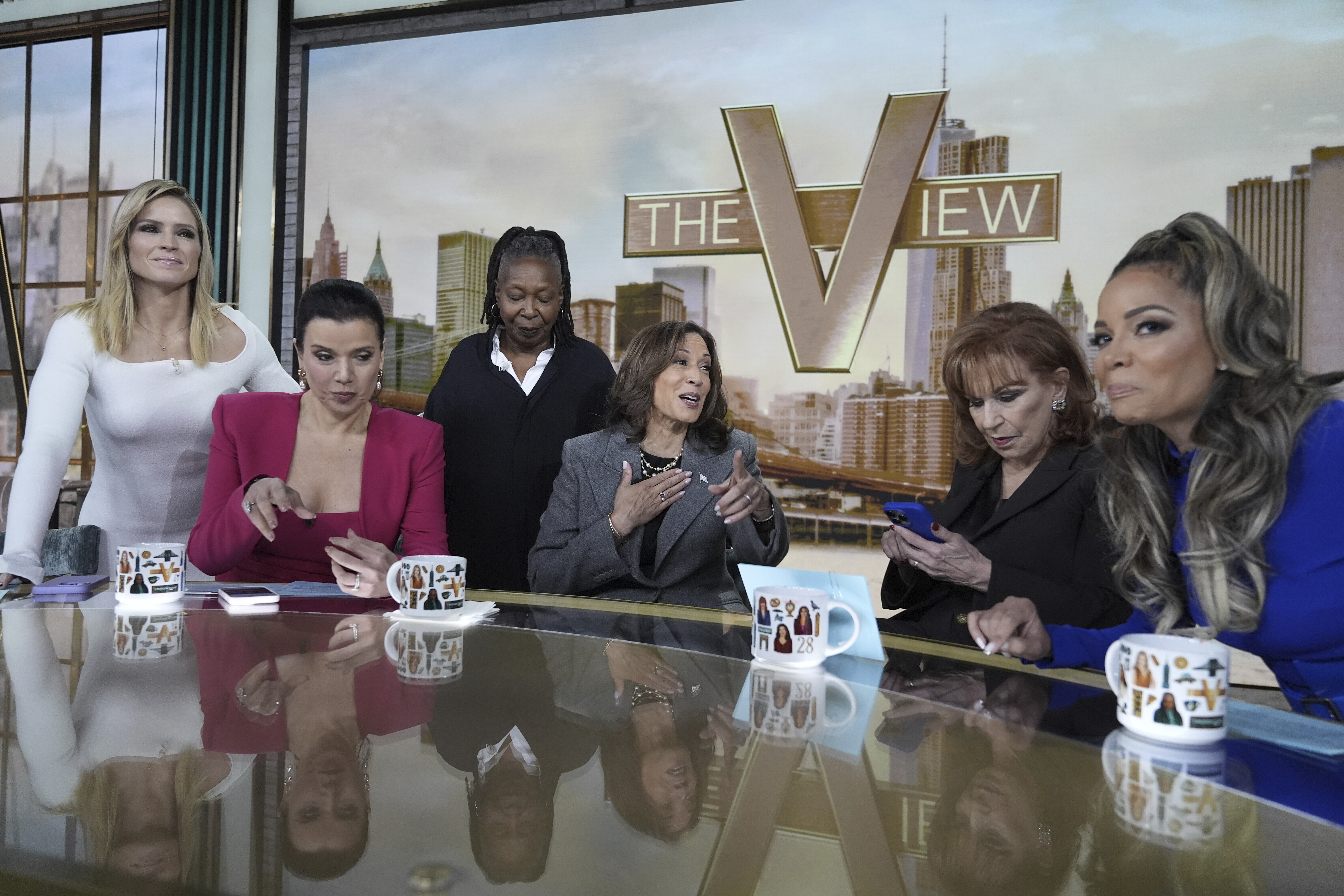 Democratic presidential nominee Vice President Kamala Harris chats with the hosts during a commercial break at The View, Tuesday, Oct. 8, 2024, in New York. From left are Sara Haines, Ana Navarro, Whoopi Goldberg, Harris, Joy Behar and Sunny Hostin. (AP Photo/Jacquelyn Martin)