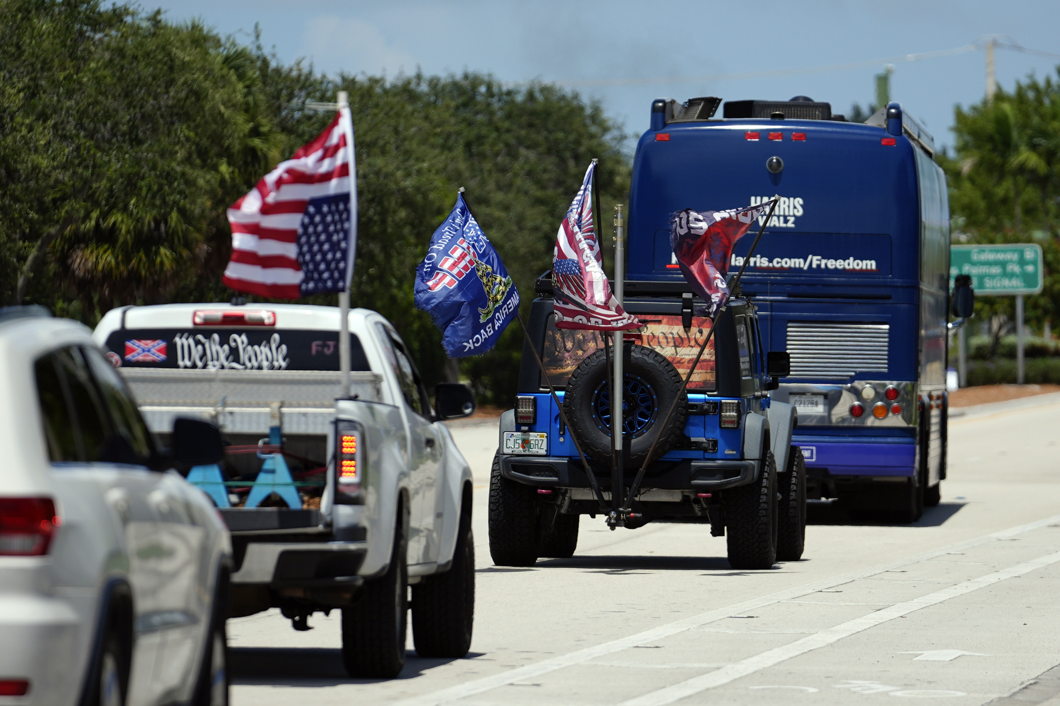 Trump supporters who turned out to protest against abortion follow the bus at the start of the "Reproductive Freedom Bus Tour" by the campaign of Democratic presidential nominee Vice President Kamala Harris and running mate Gov. Tim Walz, Tuesday, Sept. 3, 2024, in Boynton Beach, Fla. (AP Photo/Rebecca Blackwell)