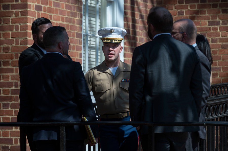 FILE - U.S. Marine Corp Major Joshua Mast, center, talks with his attorneys during a break in a hearing in an ongoing custody battle over an Afghan orphan, at the Circuit Courthouse in Charlottesville, Va., March 30, 2023. (AP Photo/Cliff Owen, File)