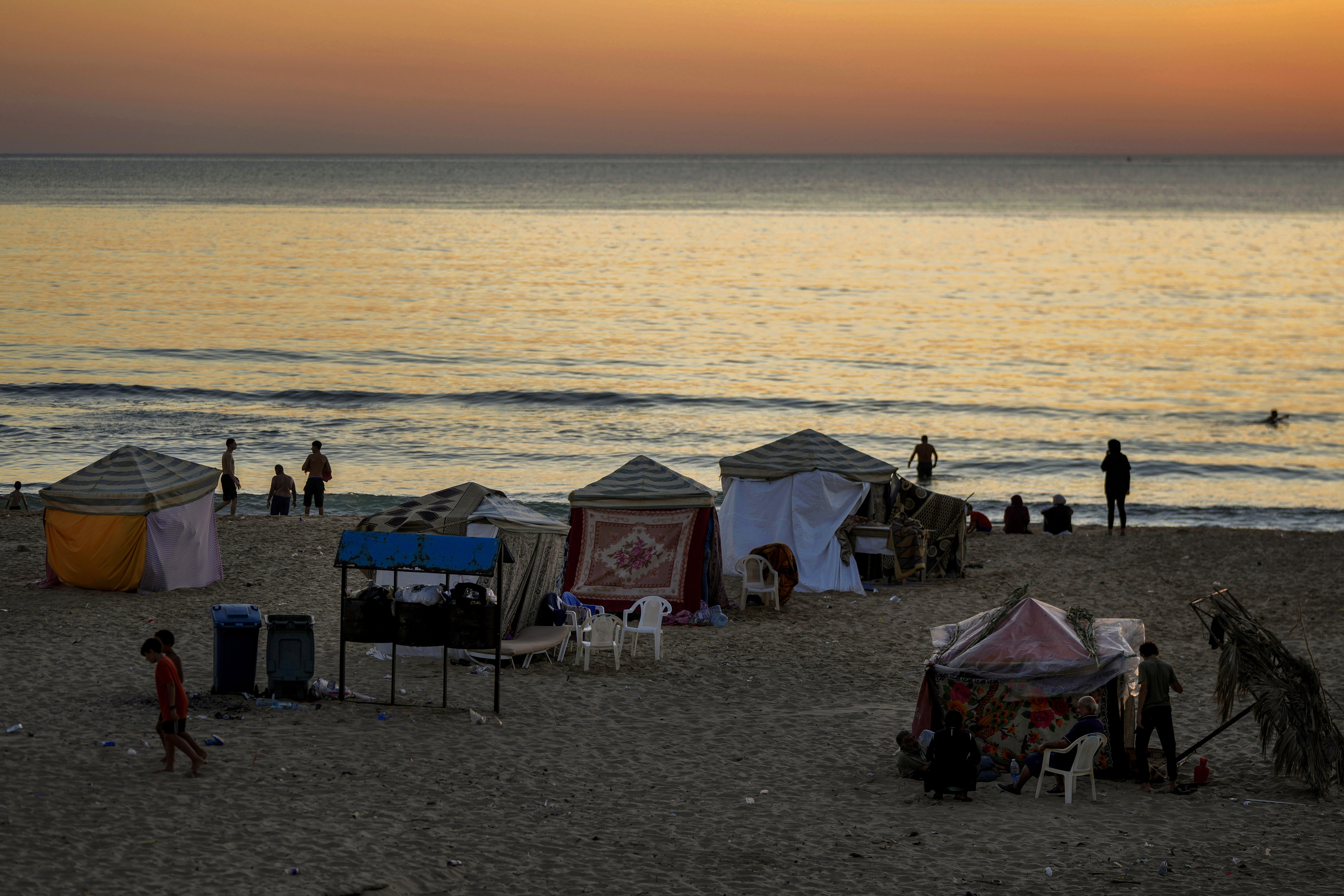 Tents set up as temporary shelters by displaced families fleeing the Israeli airstrikes in the south and Dahiyeh, are seen along the Ramlet al-Baida public beach in Beirut, Lebanon, Tuesday Oct. 8, 2024. (AP Photo/Bilal Hussein)