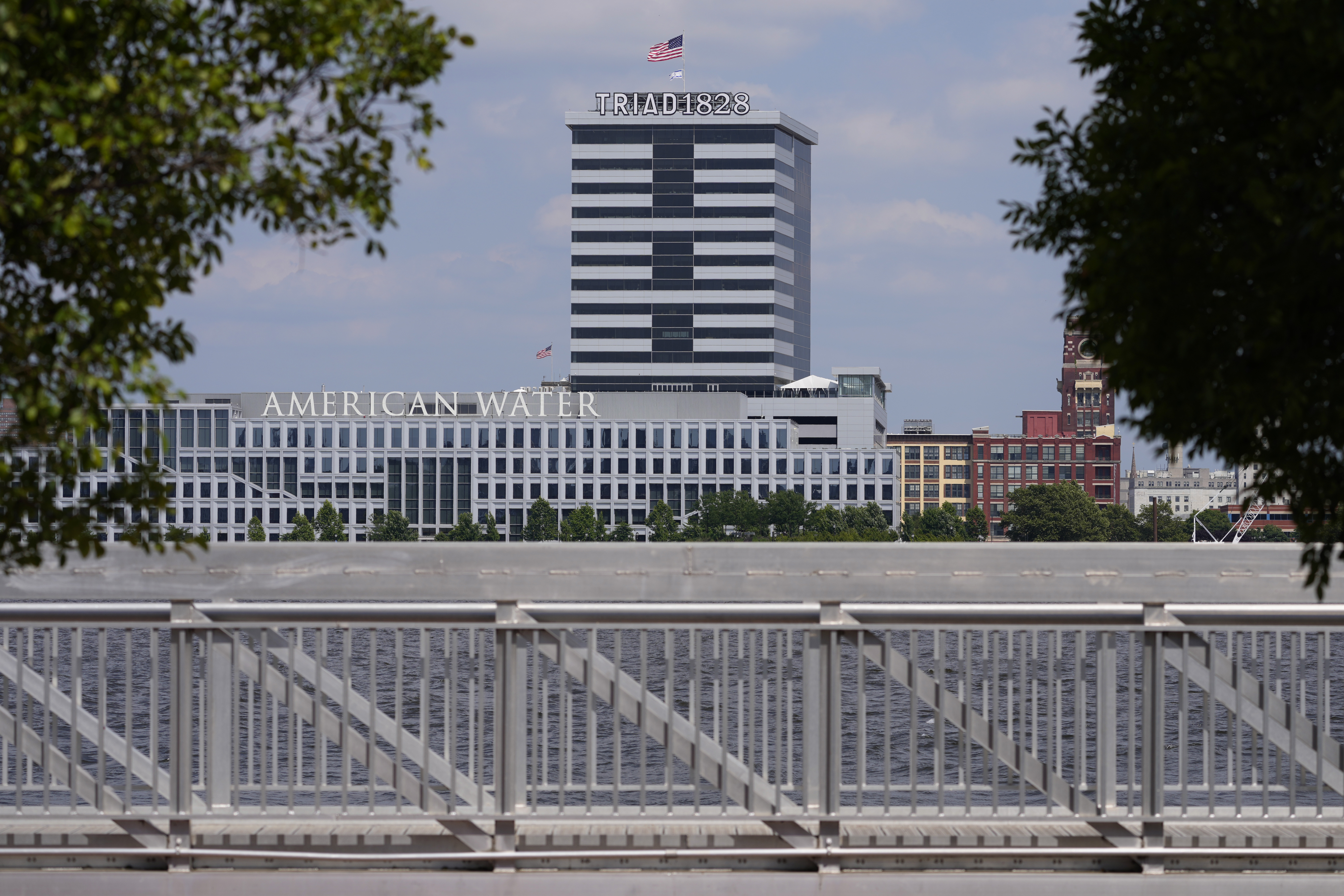 FILE - The largest regulated water and wastewater utility company in the U.S., American Water, its building in Camden, N.J., seen in the foreground on June 17, 2024, says it was the victim of a cyberattack, prompting the firm to pause billing to customers. (AP Photo/Matt Slocum, File)