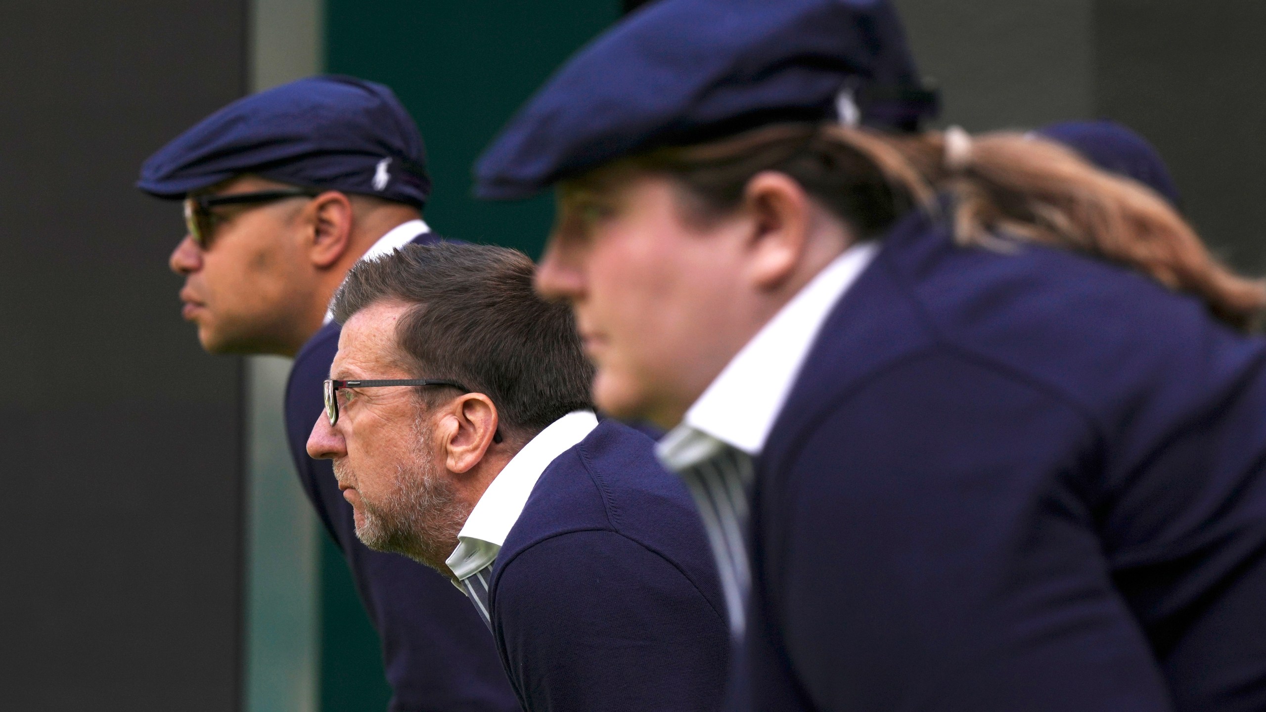 FILE - Line judges concentrate as Russia's Daniil Medvedev plays Britain's Arthur Fery in a first round men's singles match on day three of the Wimbledon tennis championships in London, Wednesday, July 5, 2023. That long-held Wimbledon tradition of line judges dressed in elegant uniforms is no more. The All England Club has announced that artificial intelligence will be used to make the 'out' and 'fault' calls at the championships from 2025. (AP Photo/Alberto Pezzali, File)