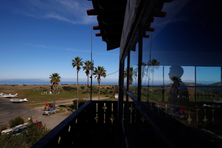 FILE - Catalina Island Conservancy Airport Manager Justin Bollum looks out of the airport tower as U.S. Marines and Navy Seabees rebuild the mountaintop runway on Santa Catalina Island, Calif., Friday, Jan. 25, 2019. (AP Photo/Damian Dovarganes, File)