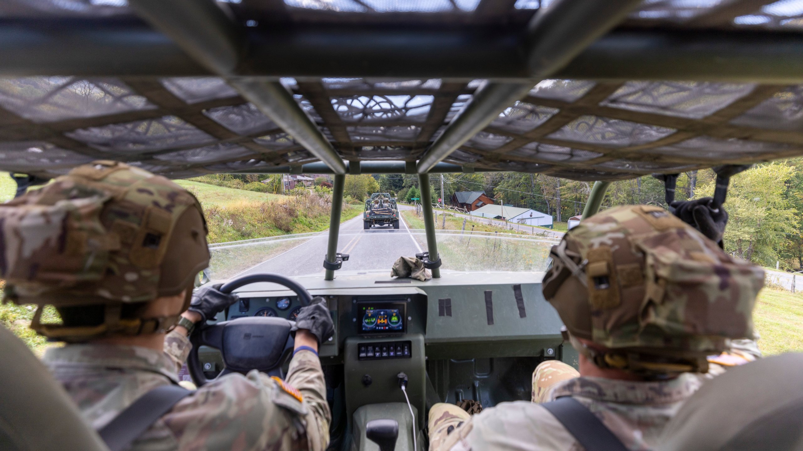 Soldiers with the 101st Airborne Division Air Assault, 2nd Brigade Combat Team, from Fort Campbell, Kentucky, use Infantry Squad Vehicles to deliver water, food, toiletries, and other aid to residents in the Soco Gap community in Maggie Valley on Tuesday, Oct. 8, 2024. The team has been using the Maggie Valley Pavilion and Town Hall as a distribution base for relief efforts in the town following Tropical Storm Helene. (Travis Long/The News & Observer via AP)