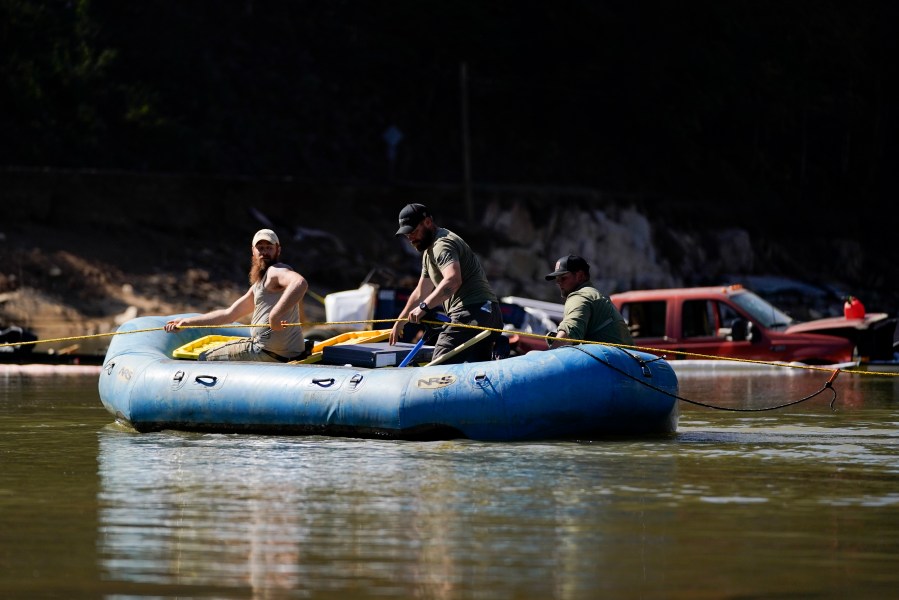 Civilian volunteers using an inflatable raft deliver supplies to residents in the aftermath of Hurricane Helene, Tuesday, Oct. 8, 2024, in Burnsville, N.C. (AP Photo/Erik Verduzco)