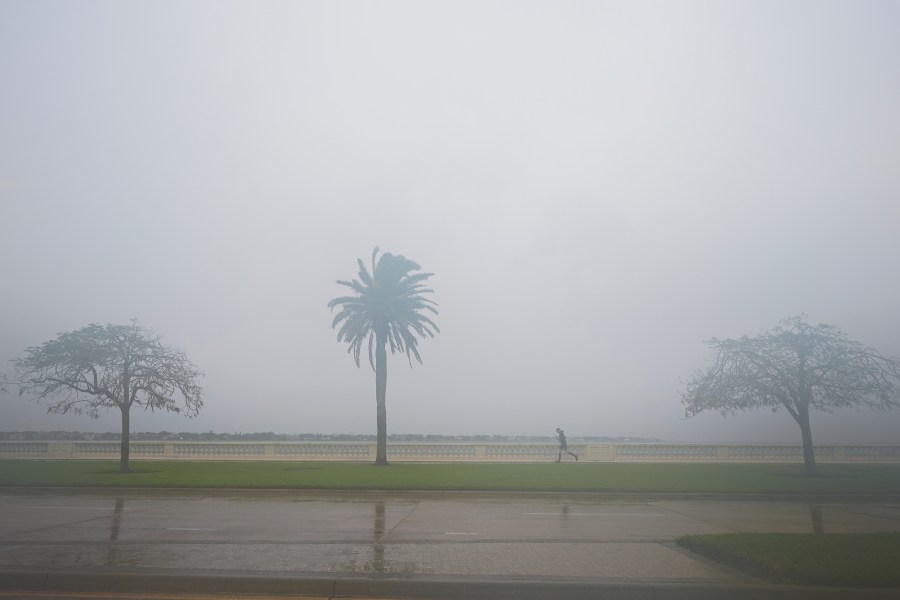 A jogger trots as rain falls ahead of the arrival of Hurricane Milton, Wednesday, Oct. 9, 2024, in Tampa, Fla. (AP Photo/Julio Cortez)