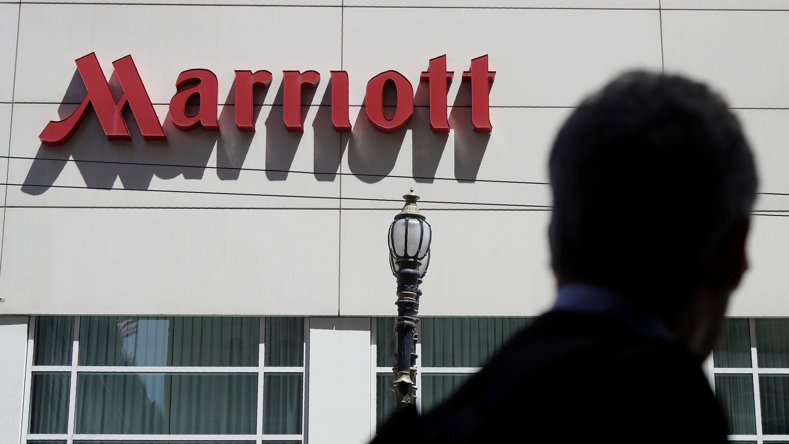 FILE - A person walks past the San Francisco Marriott Union Square hotel on July 11, 2019, in San Francisco. (AP Photo/Jeff Chiu, File)