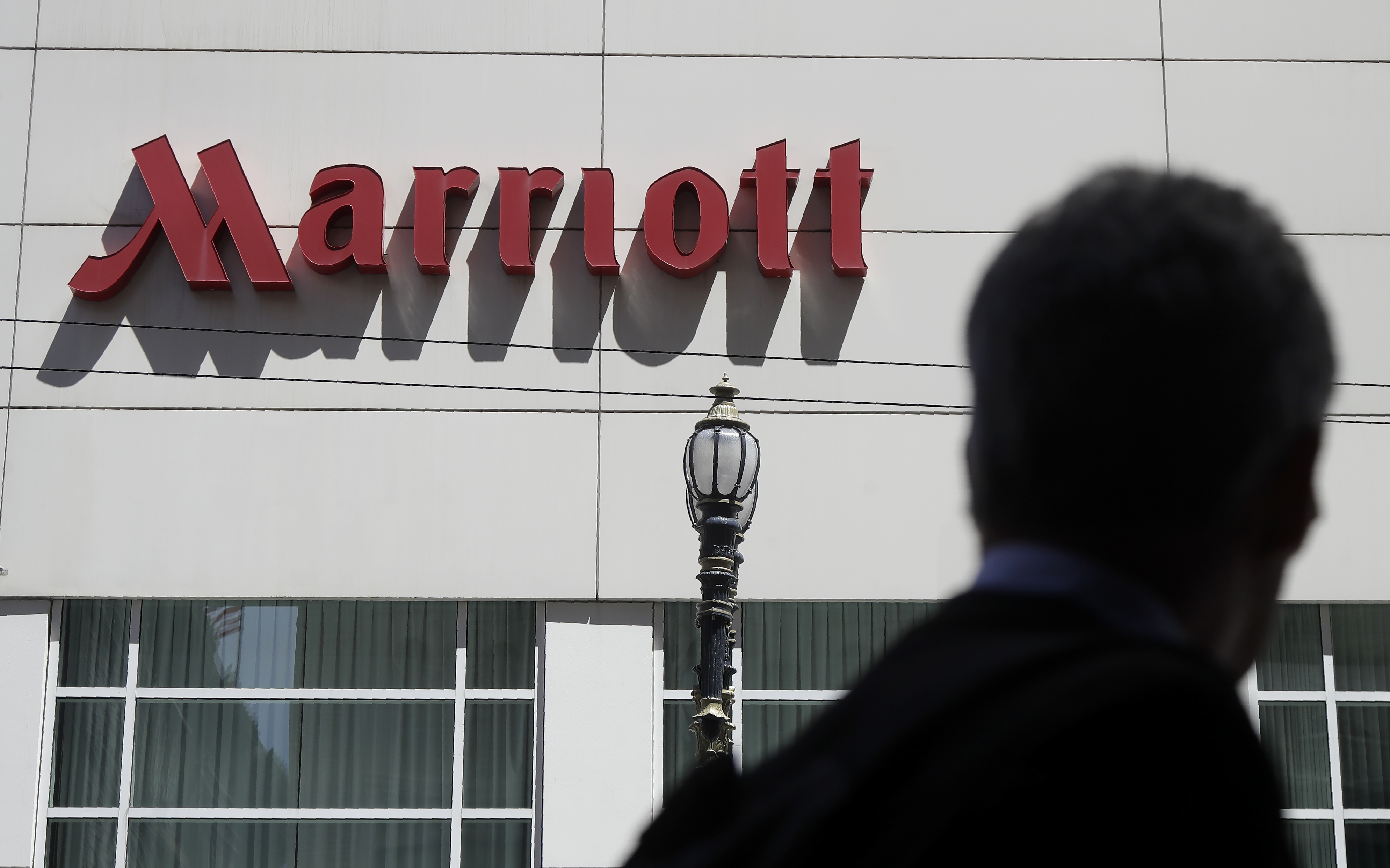 FILE - A person walks past the San Francisco Marriott Union Square hotel on July 11, 2019, in San Francisco. (AP Photo/Jeff Chiu, File)