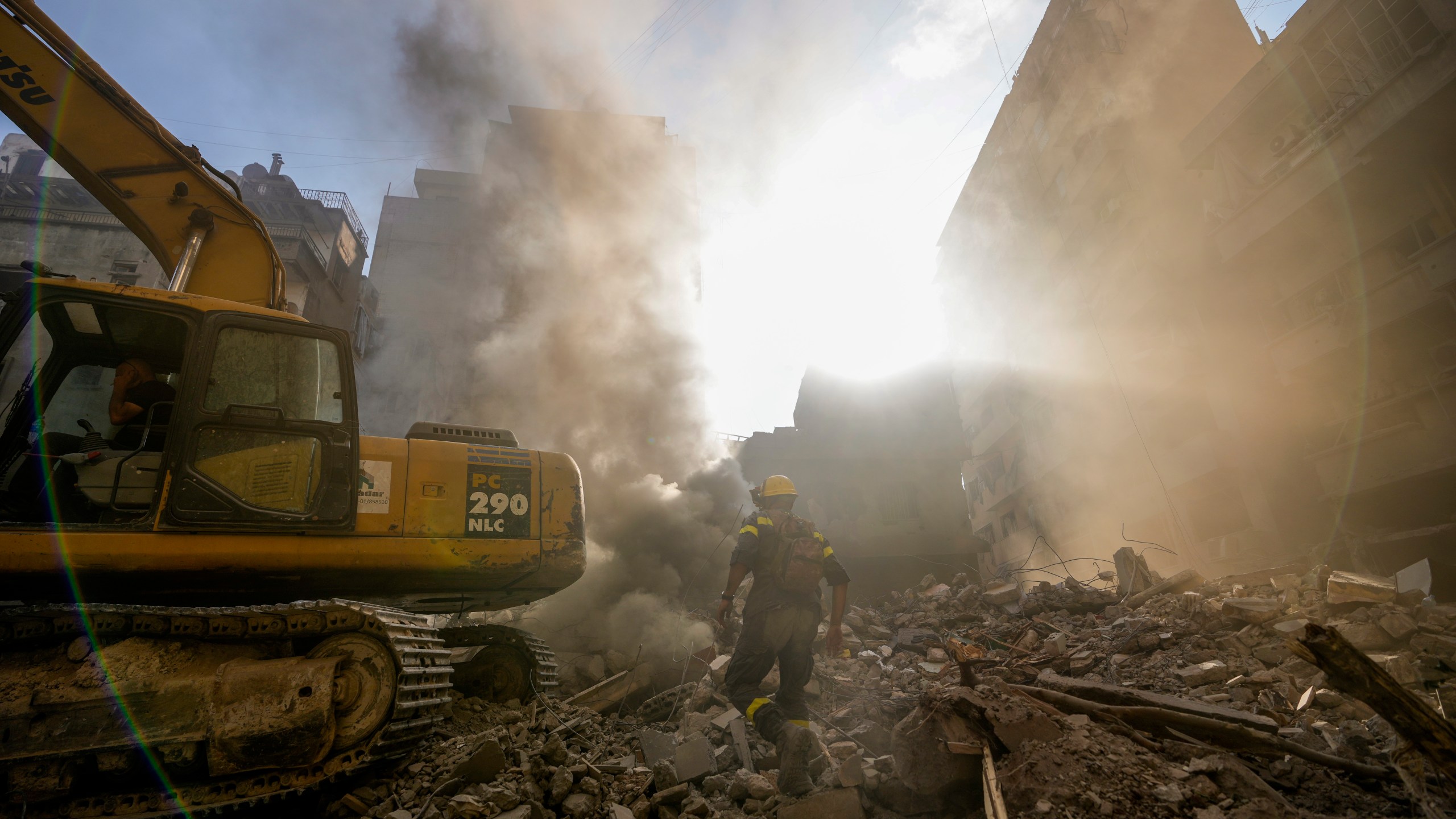 Rescue workers search for victims at the site of Thursday's Israeli airstrike in Beirut, Lebanon, Friday, Oct. 11, 2024. (AP Photo/Hassan Ammar)