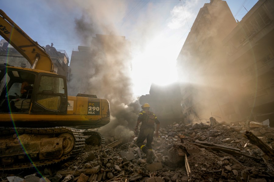 Rescue workers search for victims at the site of Thursday's Israeli airstrike in Beirut, Lebanon, Friday, Oct. 11, 2024. (AP Photo/Hassan Ammar)