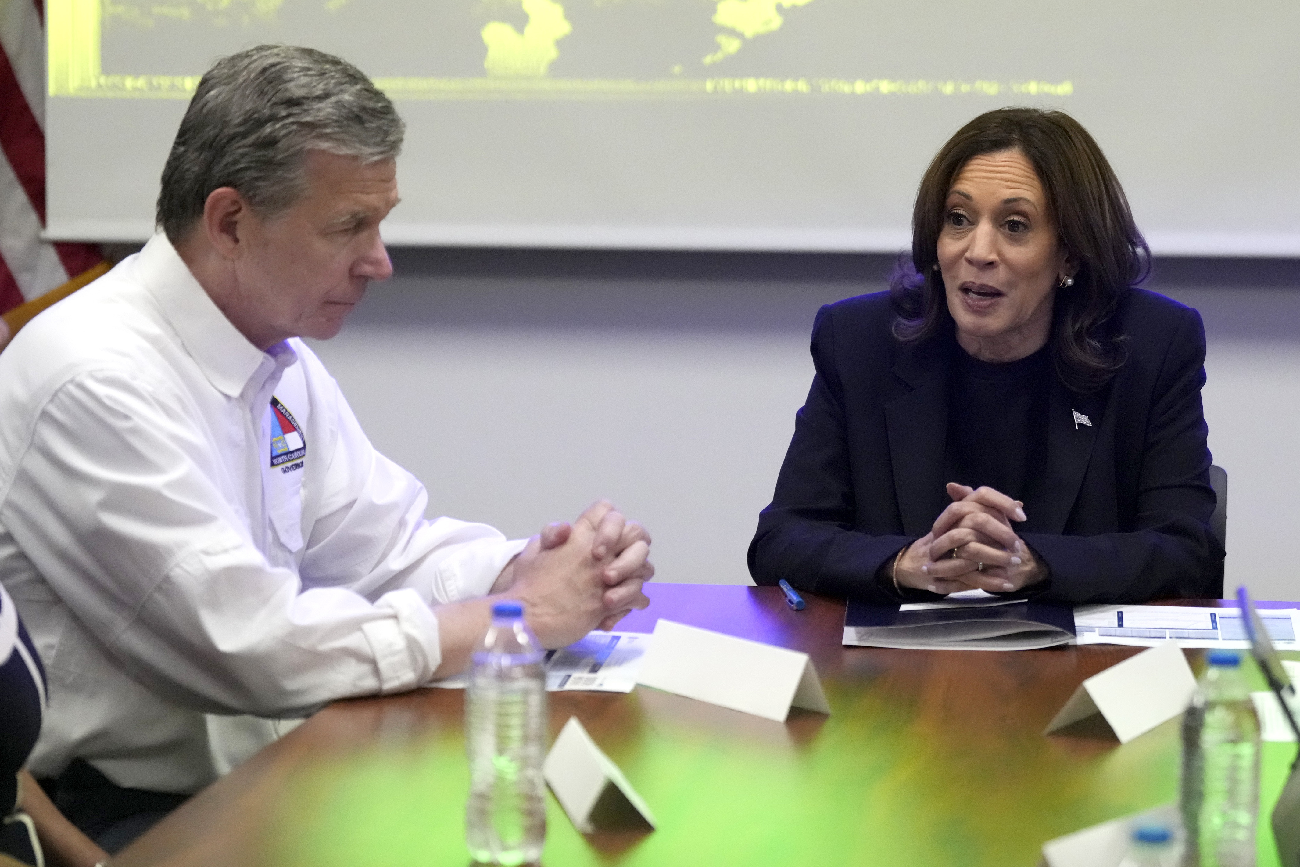 Democratic presidential nominee Vice President Kamala Harris, right, receives a briefing from North Carolina Gov. Roy Cooper on the damage from Hurricane Helene, Saturday, October 5, 2024 in Charlotte, N.C. (AP Photo/Chris Carlson)