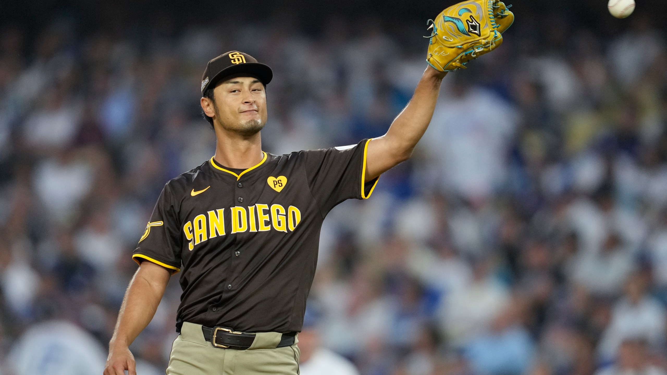 San Diego Padres pitcher Yu Darvish gets a ball back as he pitches during the fifth inning in Game 5 of a baseball NL Division Series against the Los Angeles Dodgers, Friday, Oct. 11, 2024, in Los Angeles. (AP Photo/Ashley Landis)